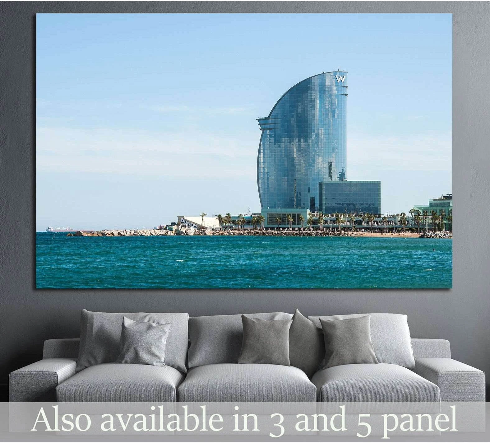 Barcelona seafront canvas print with W Hotel, turquoise sea, and pale blue sky above a sofa