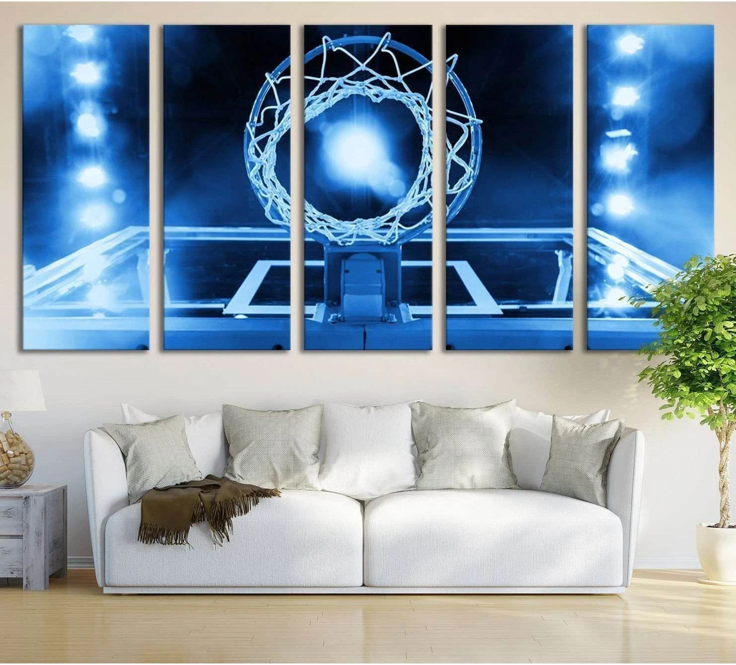 Upward view basketball hoop canvas print with glowing blue arena lights above sofa in modern living room