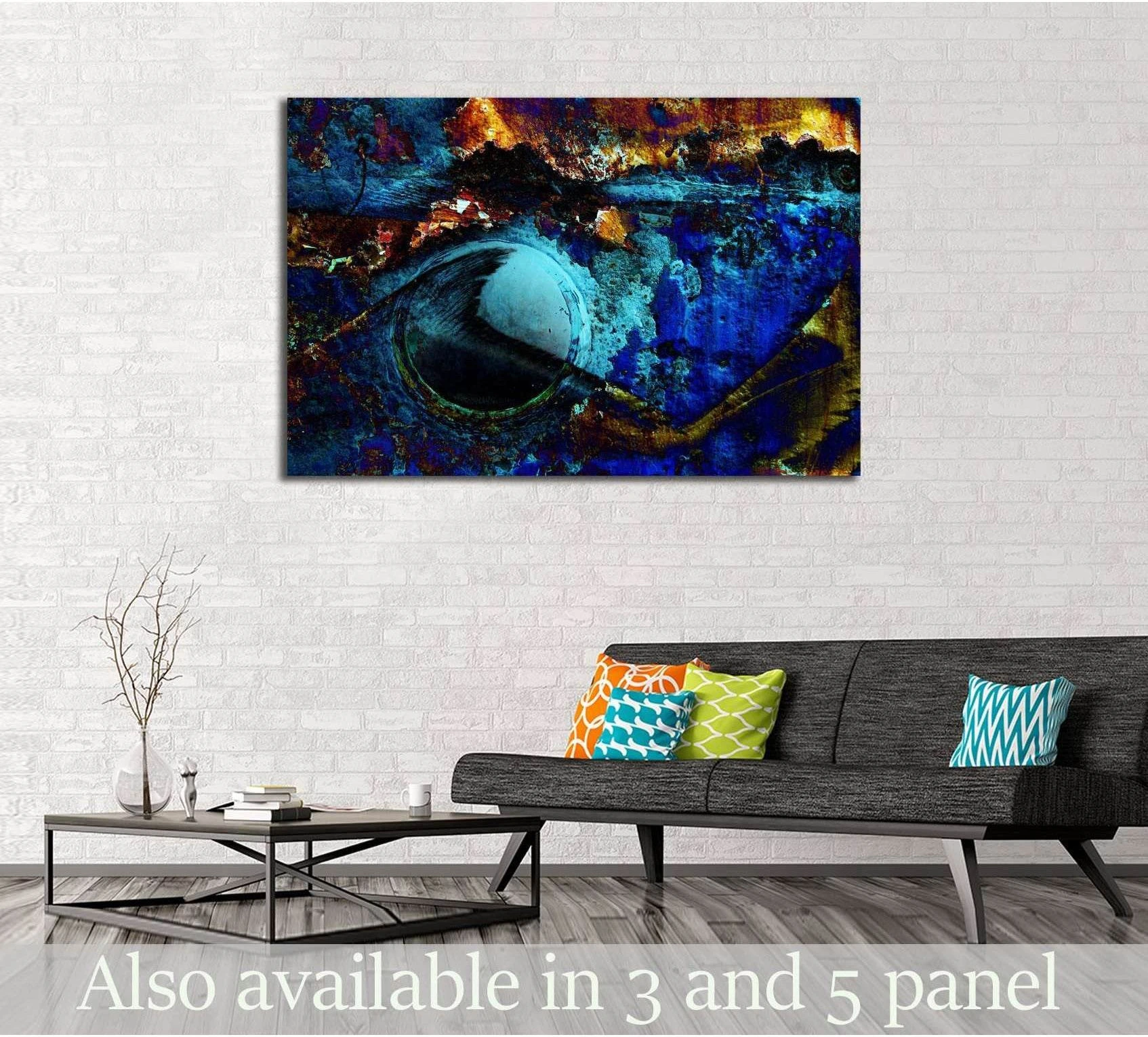 Blue abstract canvas print with swirling orb form and gold accents above a sofa in a modern living room