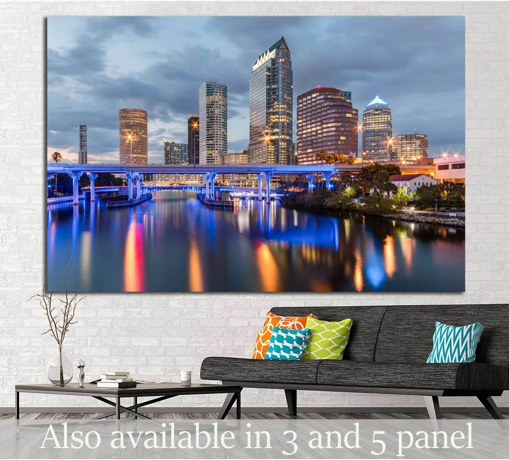 Tampa skyline canvas print with blue-lit bridge and river reflections above sofa in modern living room