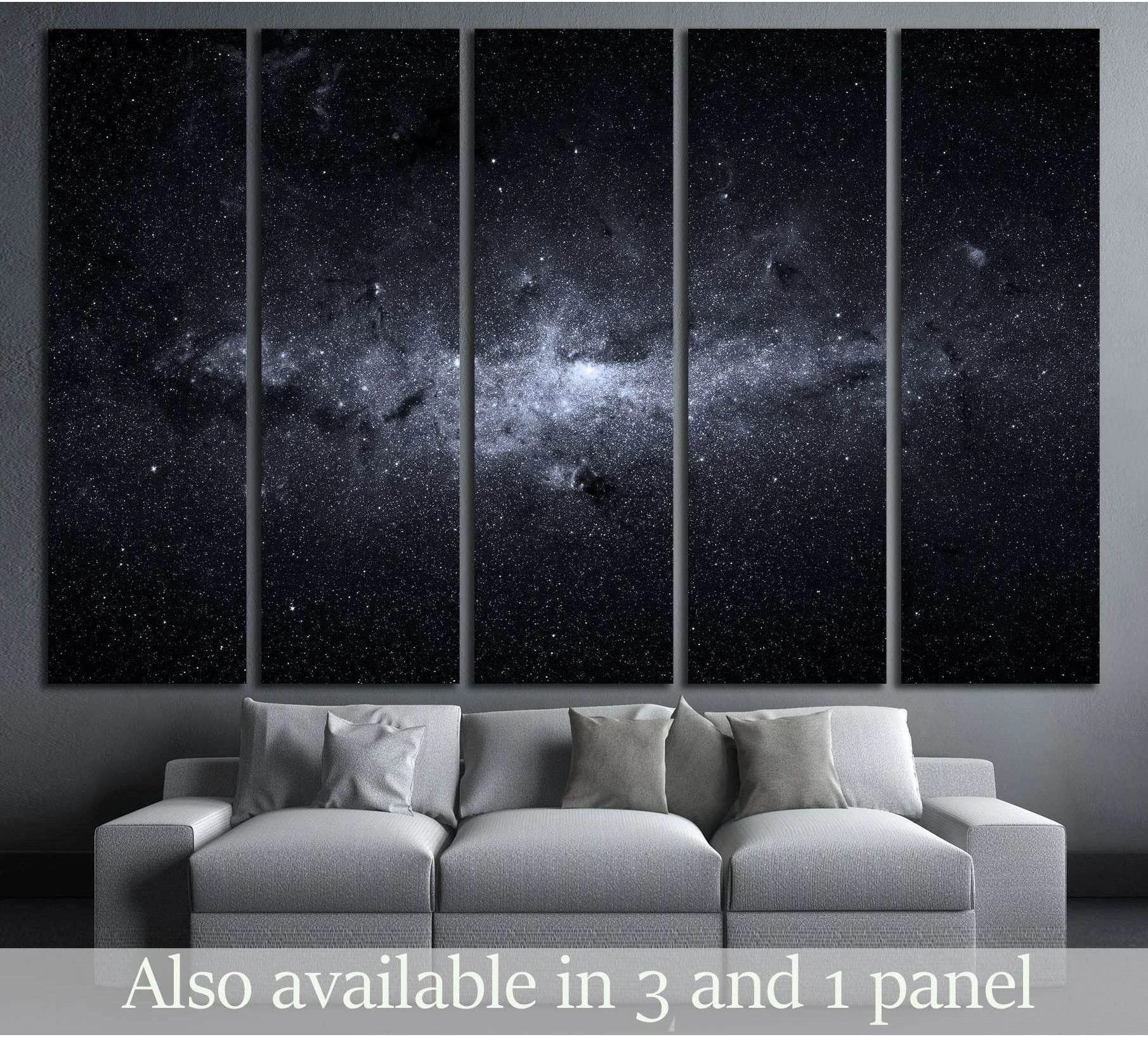 Five-panel Milky Way canvas print above a sofa in a modern living room