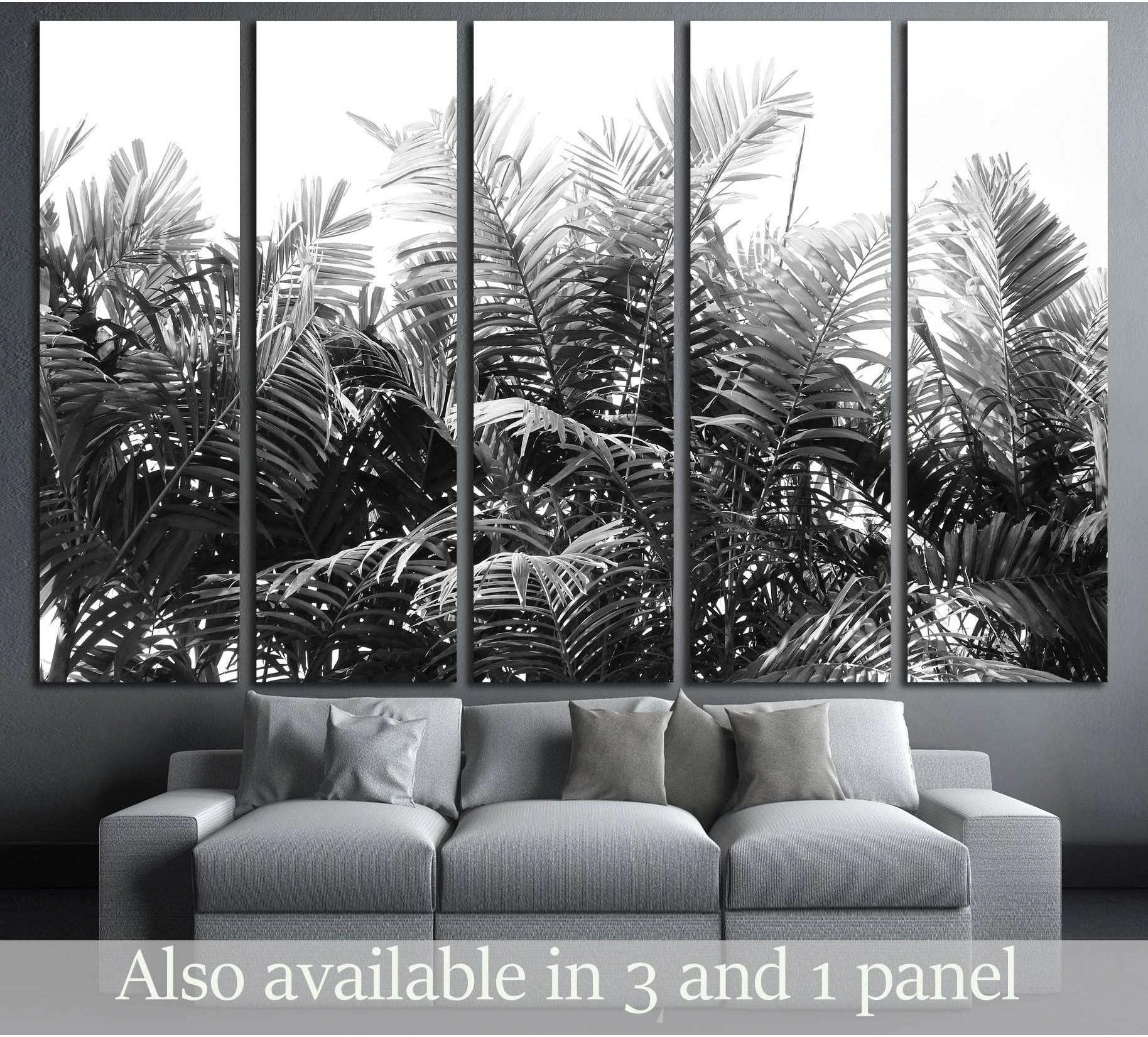 Black and white palm leaves canvas print displayed above a sofa in a modern living room