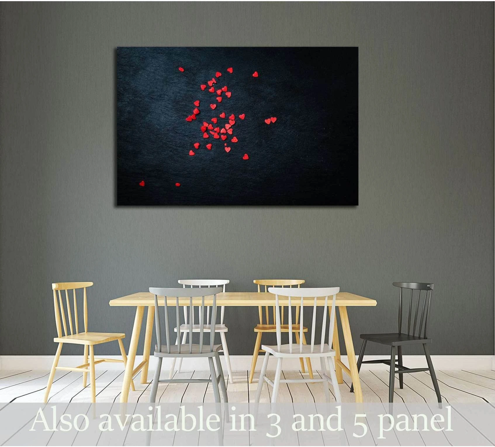 Red hearts canvas print on a black background displayed above a dining table in a modern room