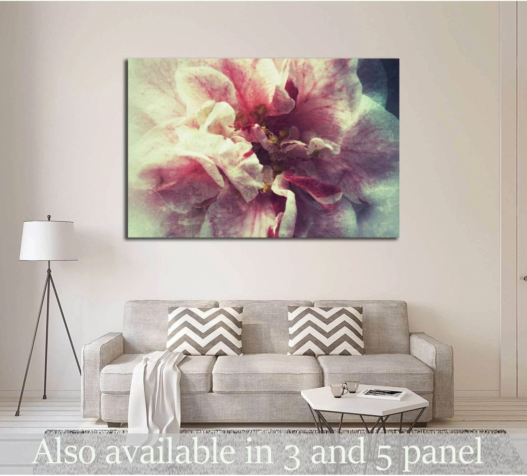 Bi-colored camellia canvas print with pink and cream petals above sofa in a neutral living room