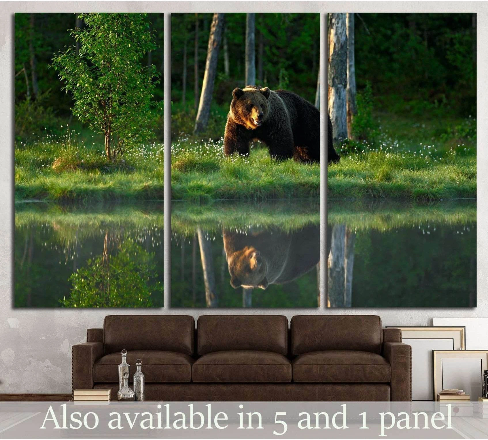 Brown bear canvas print beside a still lake with forest reflection, displayed above a sofa