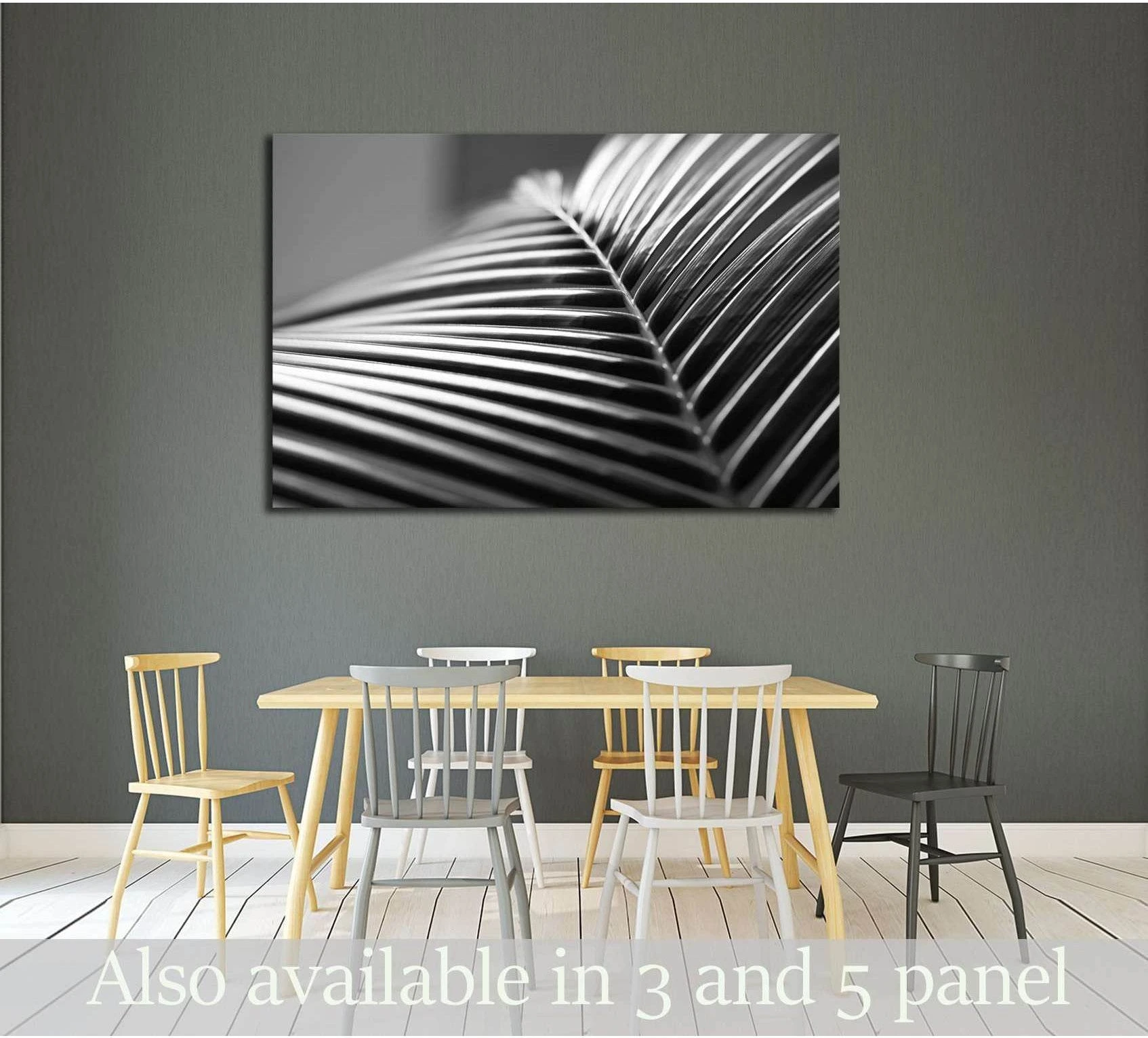 Black and white palm leaf close-up canvas print displayed above a dining table in a minimalist room