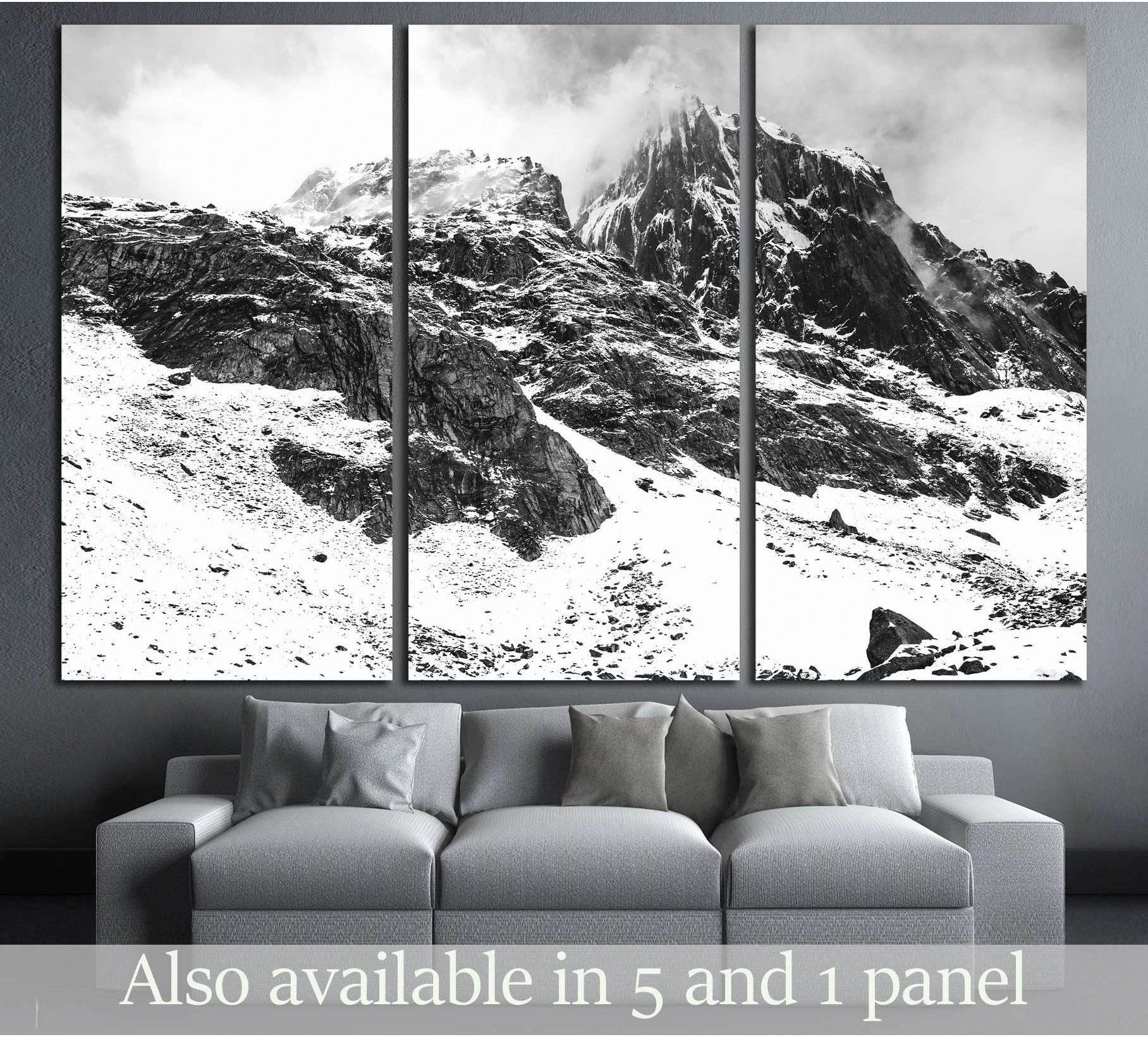 Black and white Himalayan mountain triptych canvas print above sofa in a modern living room
