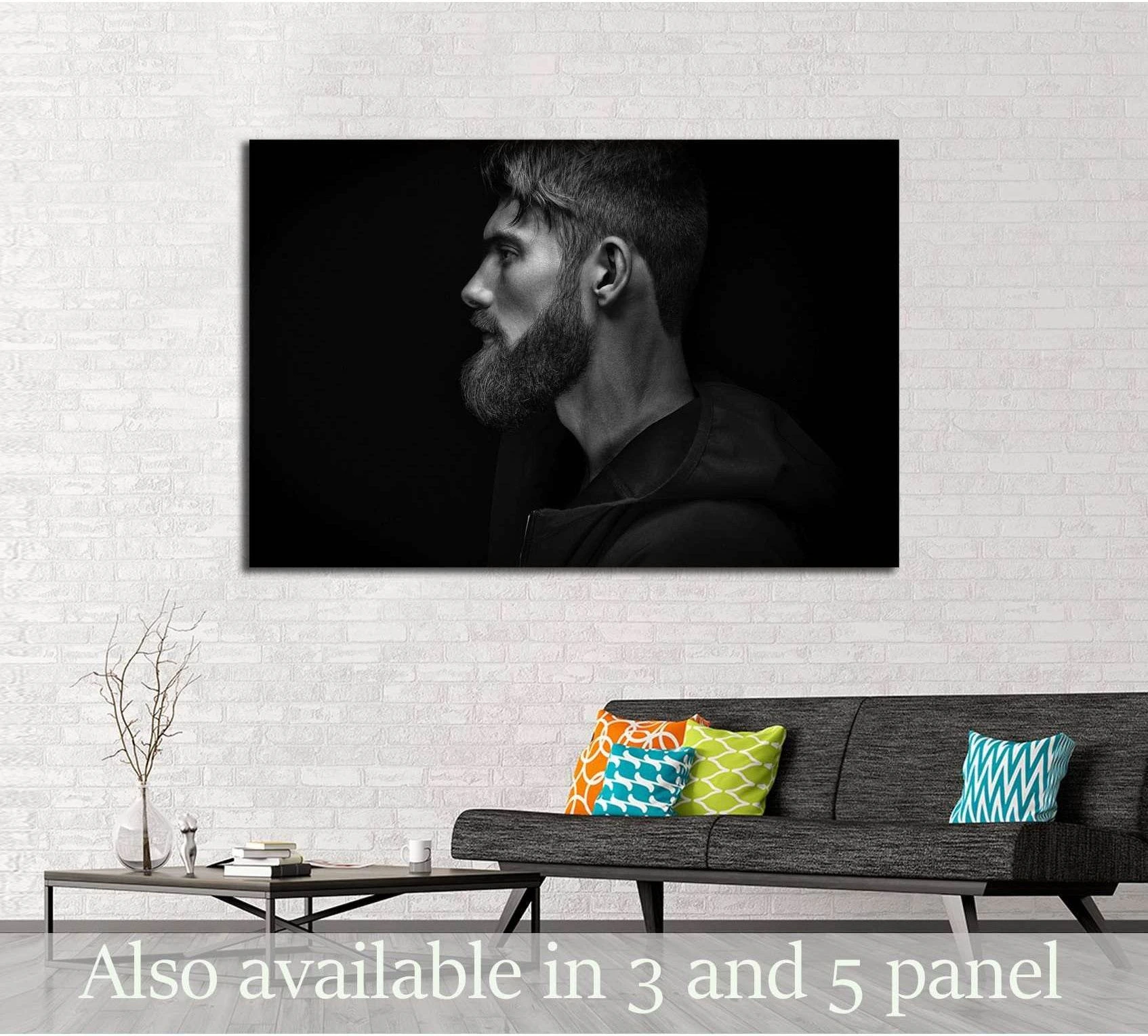 Black and white bearded man profile canvas print hung above sofa in a modern living room