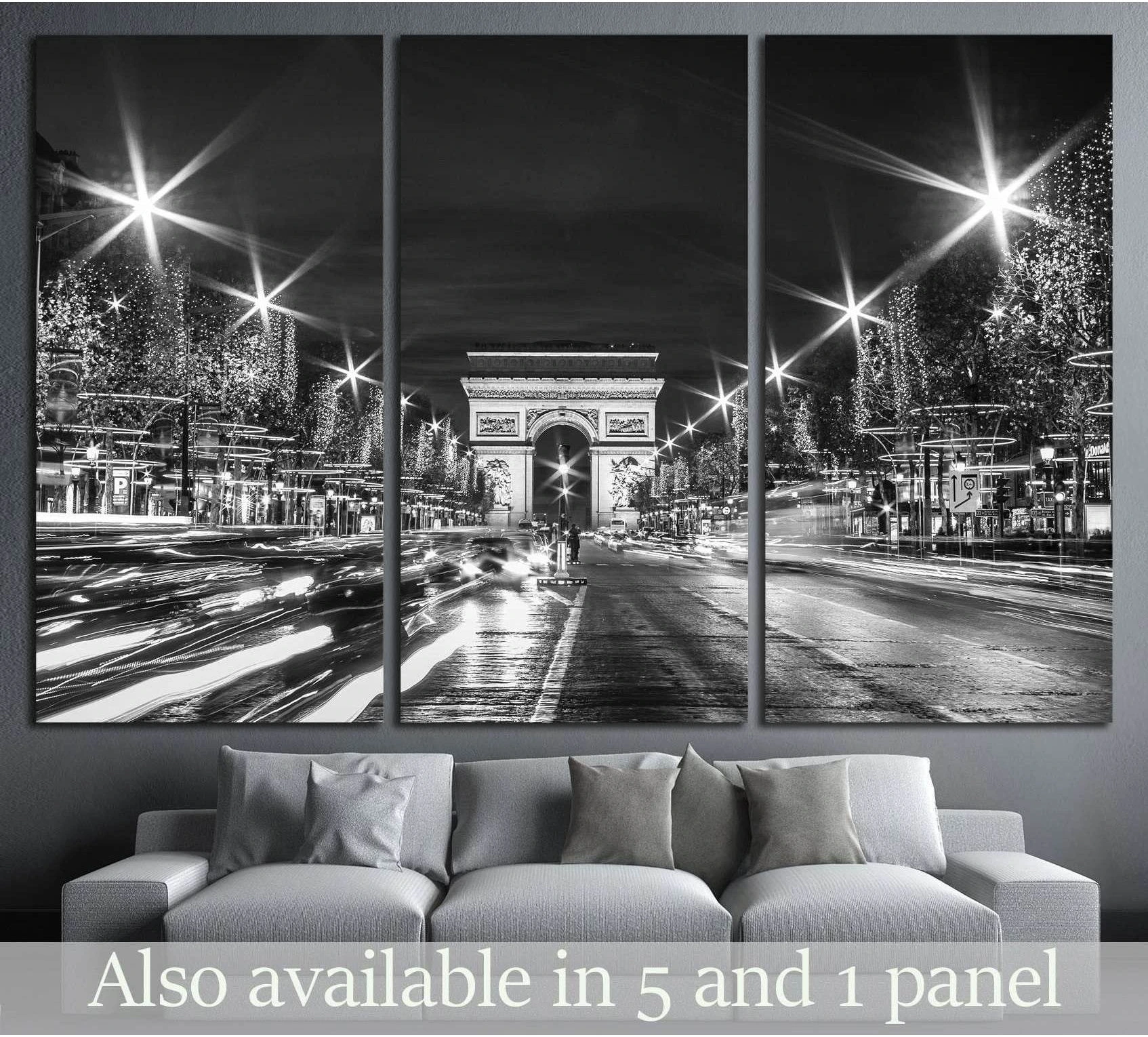 Black and white Paris Arc de Triomphe canvas print above sofa with Champs-Élysées traffic trails