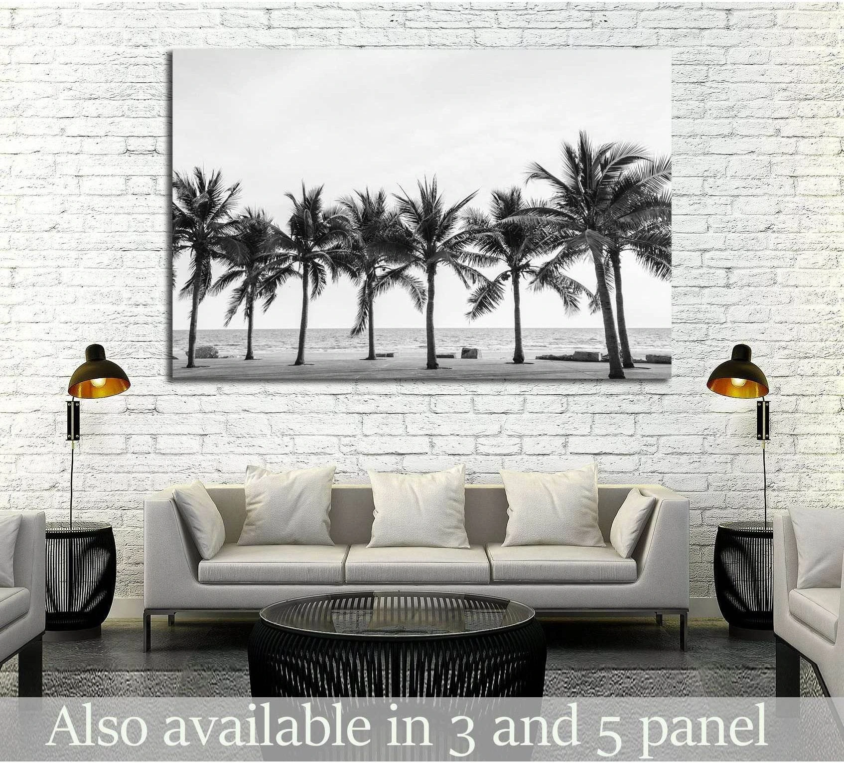 Black and white palm beach canvas print with Thailand palm trees above a sofa in a modern living room