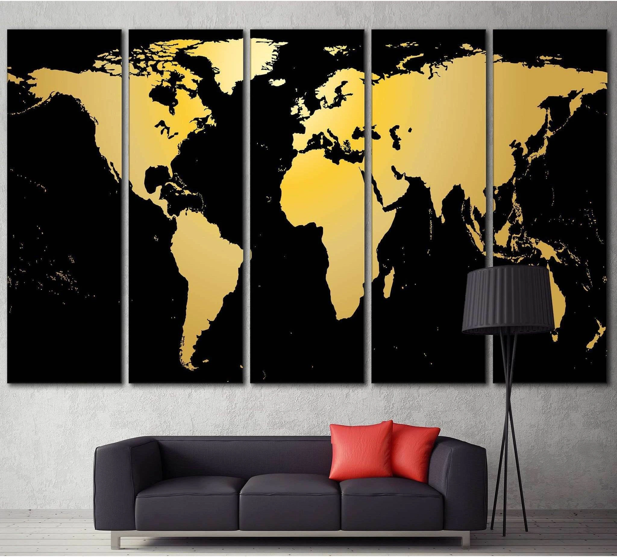 Black and gold world map multi-panel canvas print hung above a sofa in a modern living room