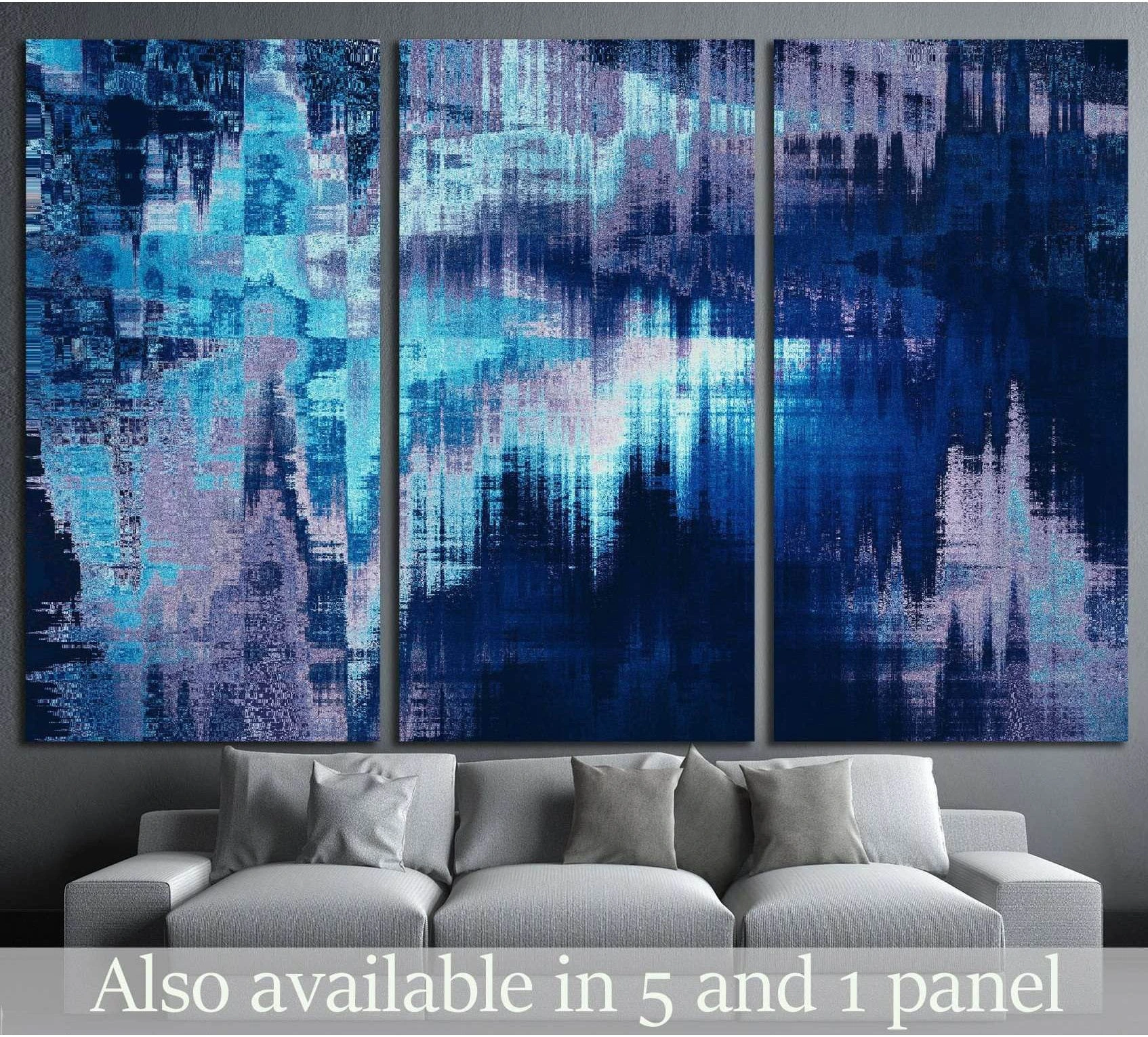 Blue abstract triptych canvas print with blurred navy, aqua, and lavender stripes above a grey sofa