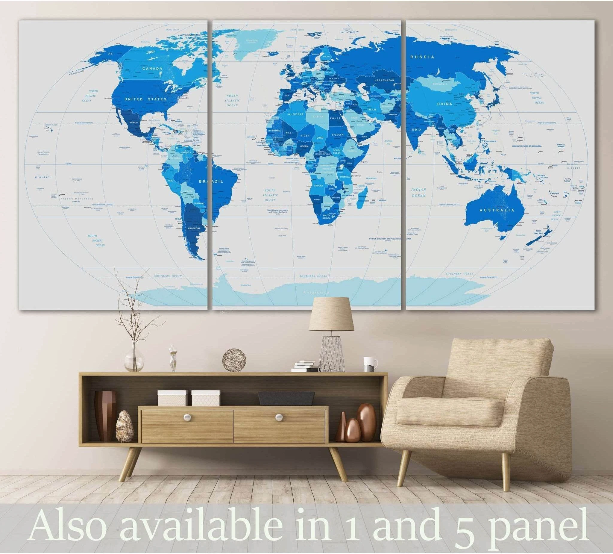 Blue world map triptych canvas print hung above a console in a modern office-style living room
