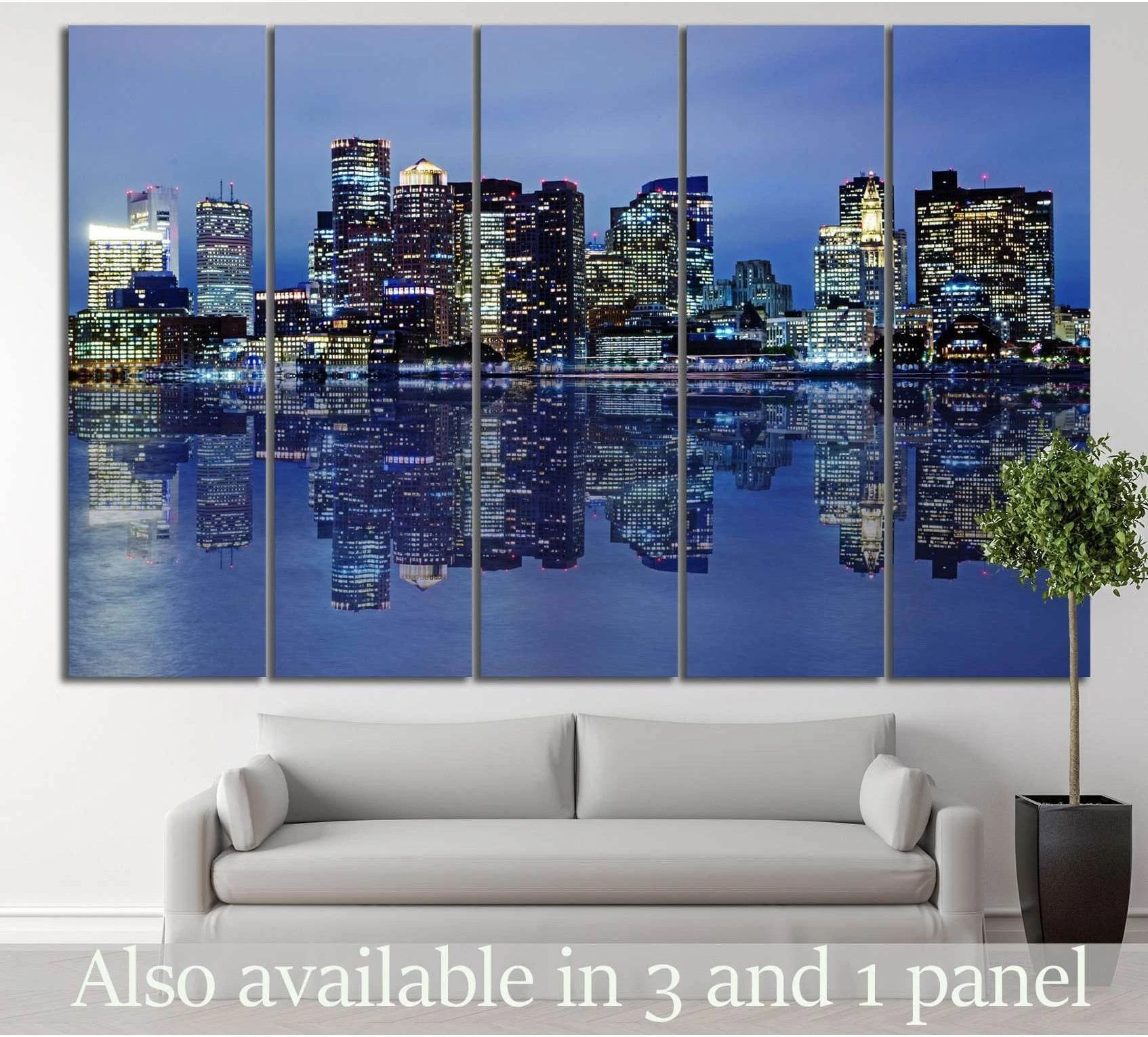 Boston skyline canvas print with night city lights reflected on calm water, displayed above a sofa in a modern living room