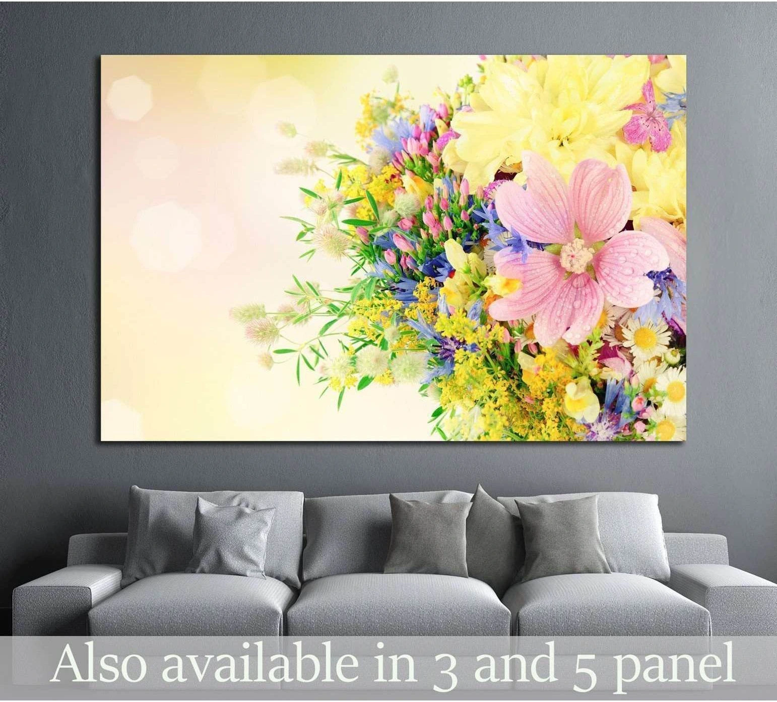 Summer bouquet canvas print with pink, yellow, and blue flowers above a gray sofa