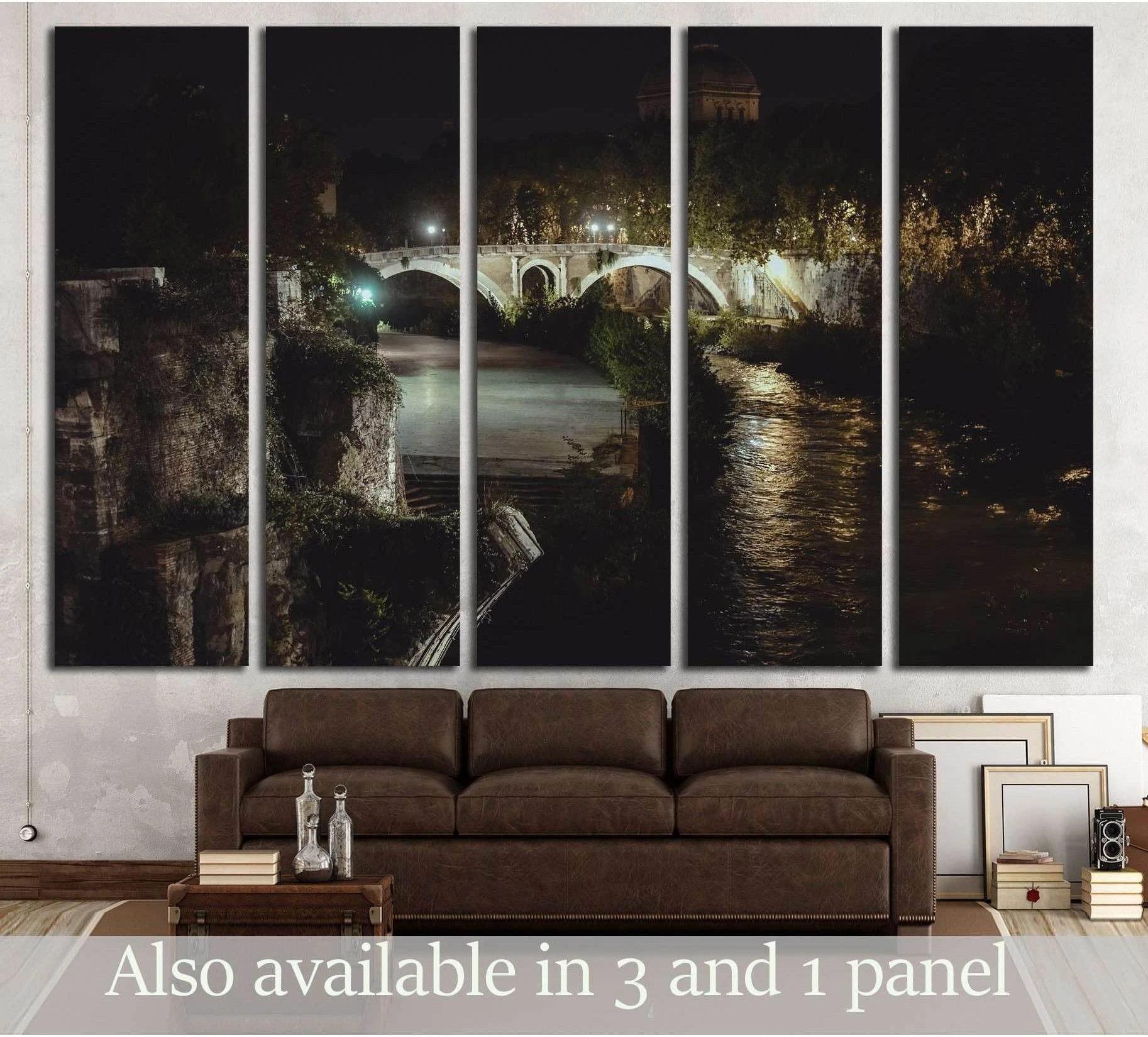 Rome night bridge canvas print with lit stone arch over the Tiber River, displayed above a brown sofa