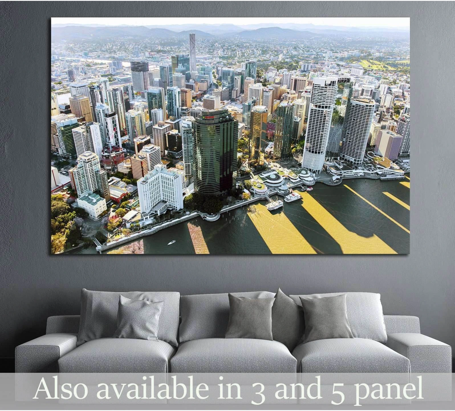 Brisbane skyline aerial canvas print above sofa in a modern living room with riverfront city view