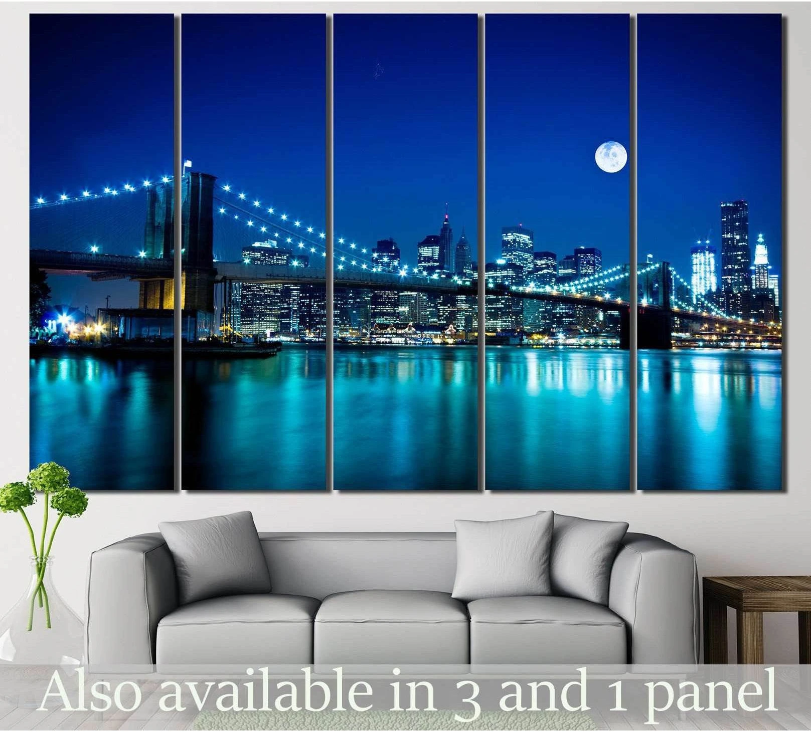 Brooklyn Bridge canvas print with NYC skyline, moonlit blue reflections, hung above a sofa in a modern living room