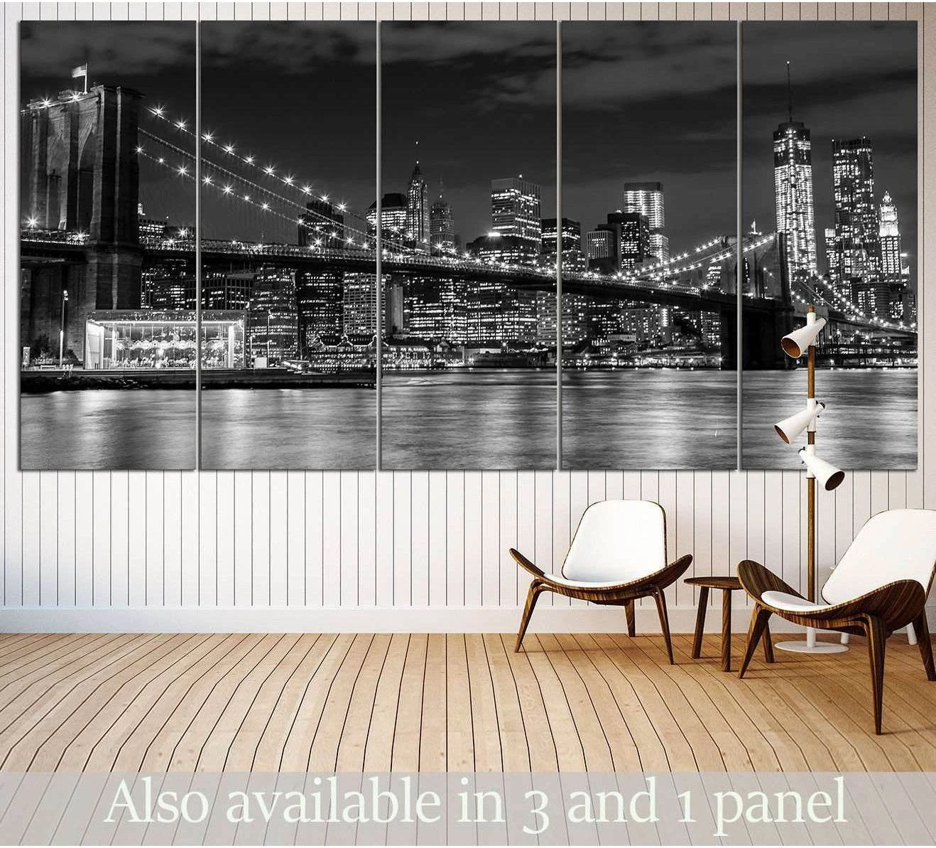 Black and white Brooklyn Bridge canvas print with Manhattan skyline at night, shown as multi-panel wall art in a modern living room