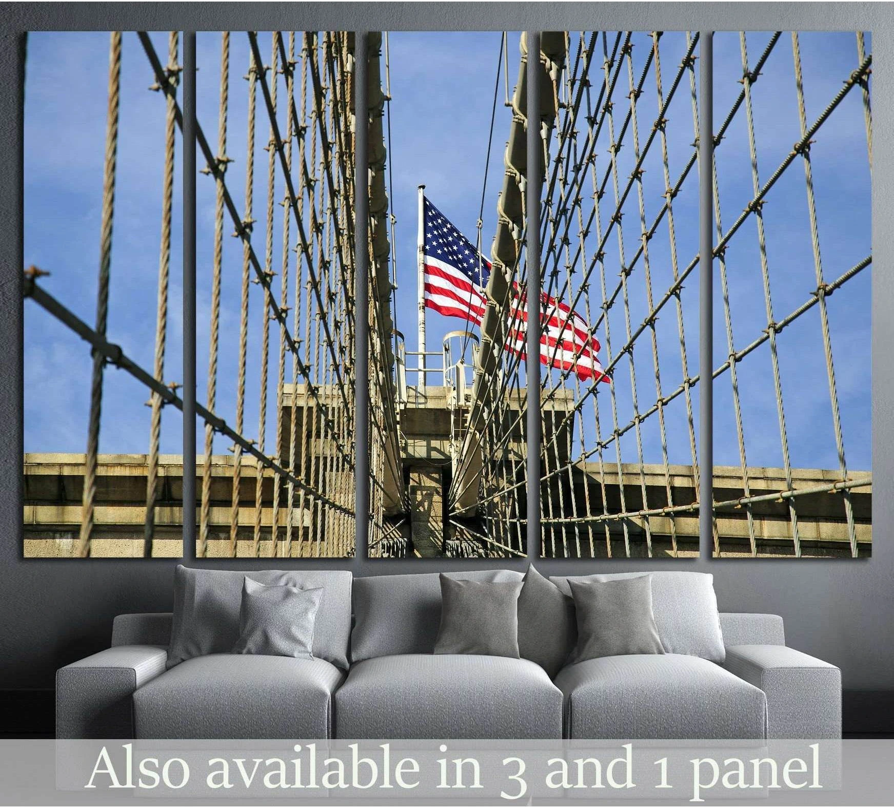 Brooklyn Bridge canvas print with American flag and suspension cables above a sofa in a living room