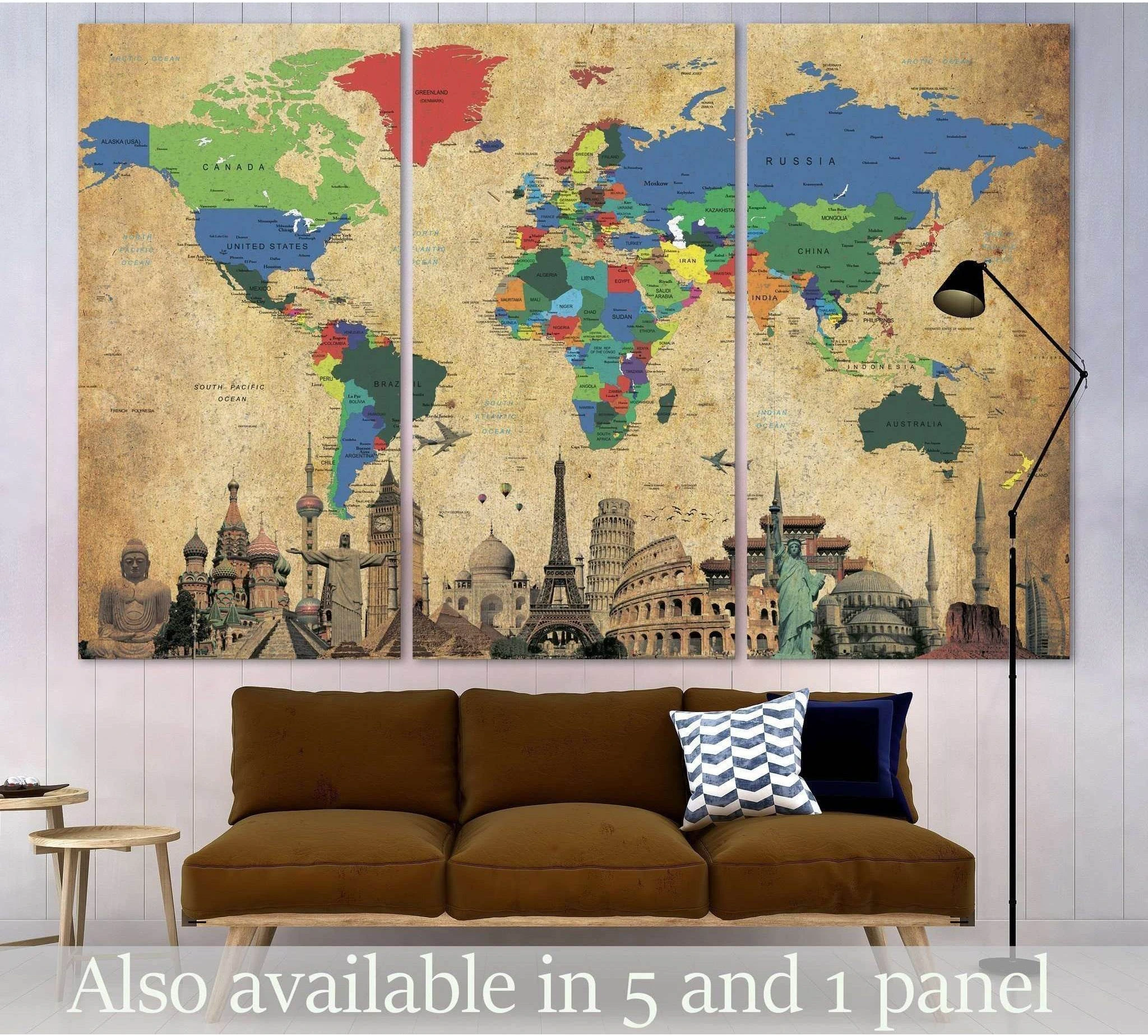 Triptych world map canvas print with colorful countries and landmark collage above a brown sofa