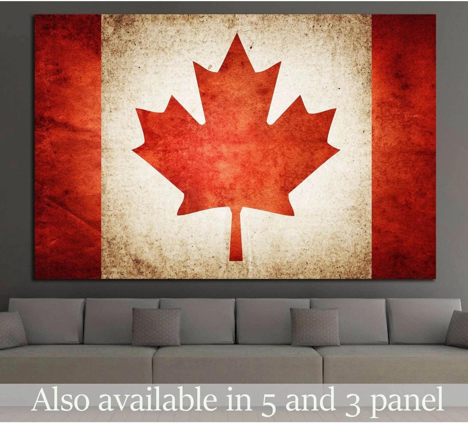 Distressed Canada flag canvas print with red maple leaf displayed above a gray living room sofa