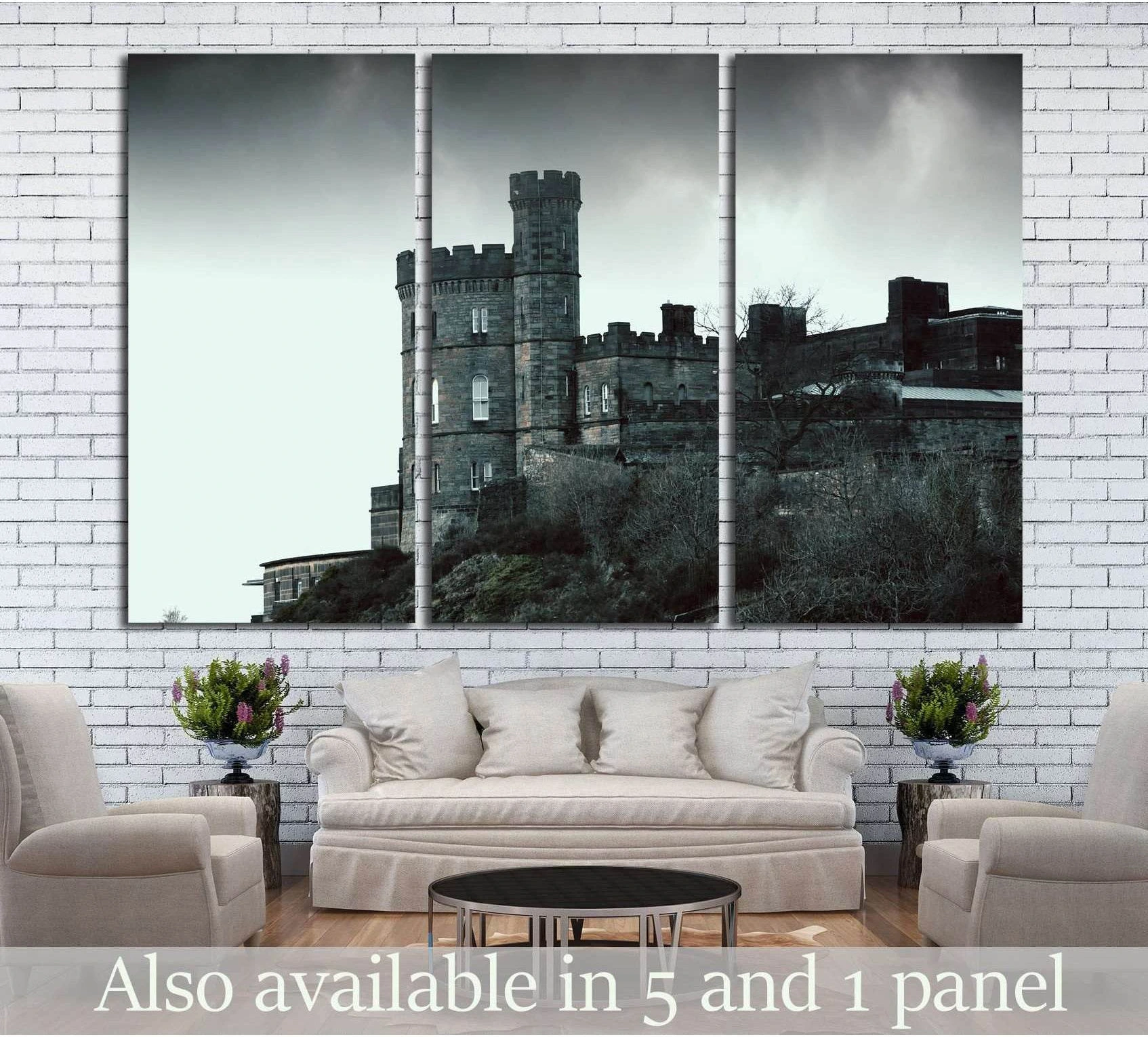 Gothic castle triptych canvas print in black and white, displayed above a sofa in a modern living room