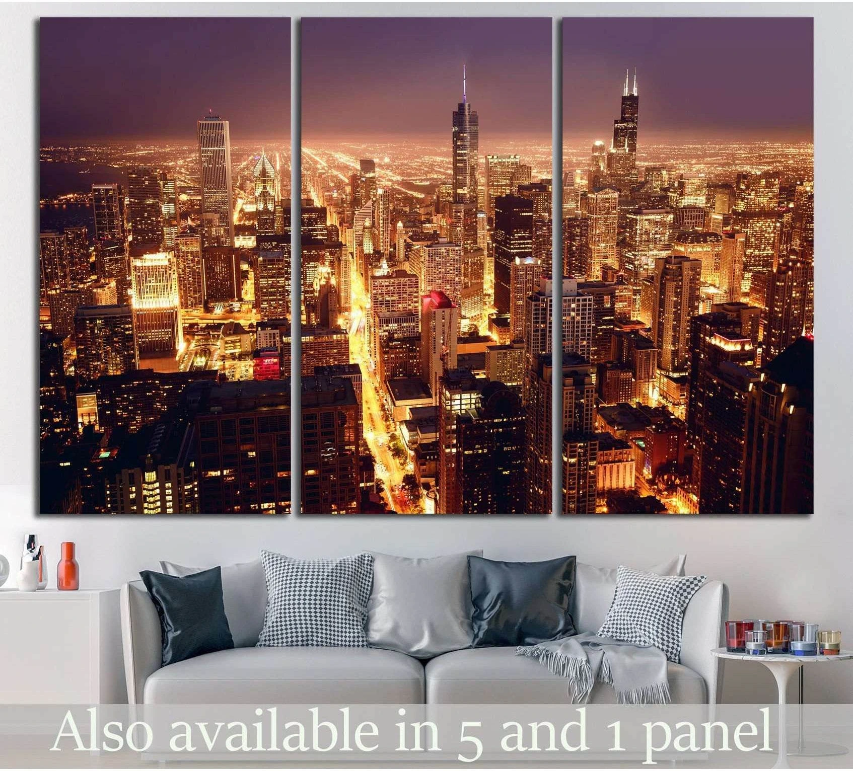 Chicago skyline triptych canvas print with glowing night city lights above sofa in modern living room