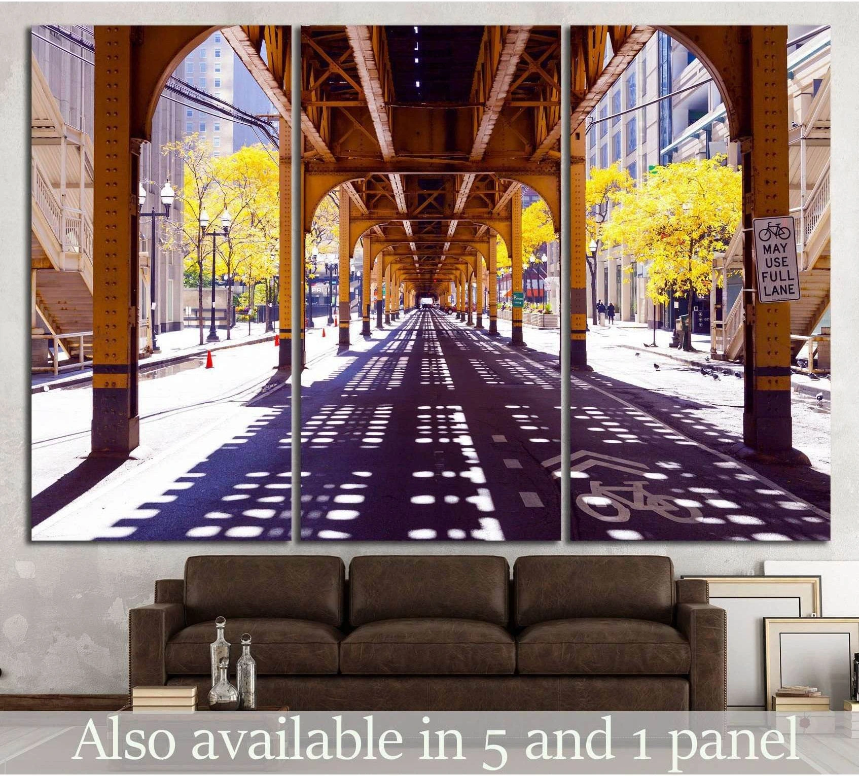 Chicago El tracks canvas print with yellow autumn trees, long street shadows, displayed above sofa
