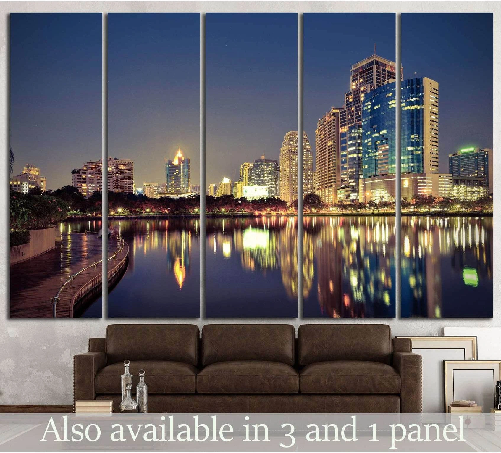 Night city skyline canvas print with waterfront reflections hung above sofa in a modern living room