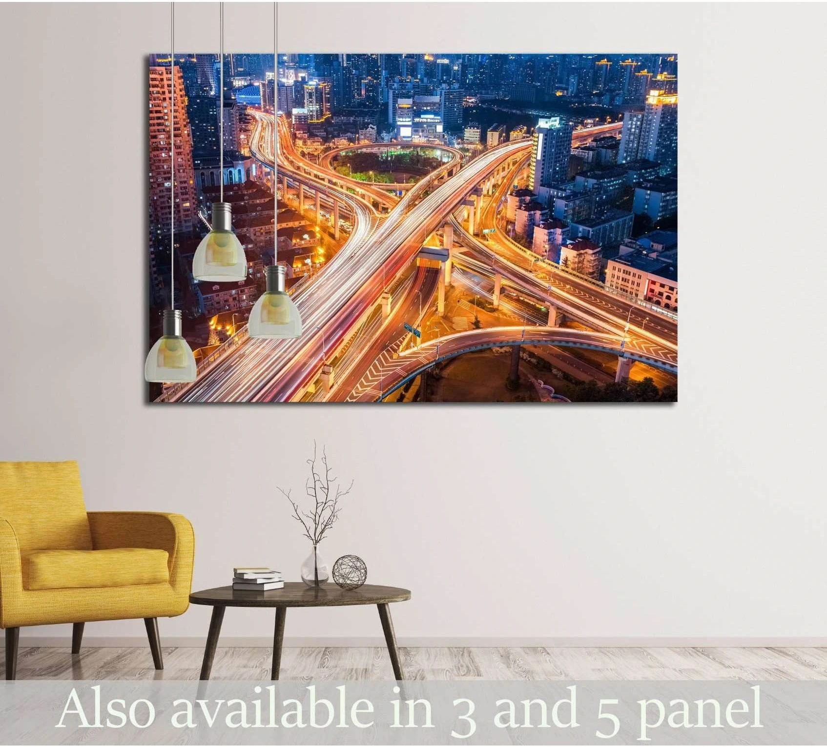 Night city interchange canvas print with glowing highway light trails above chair in a modern living room