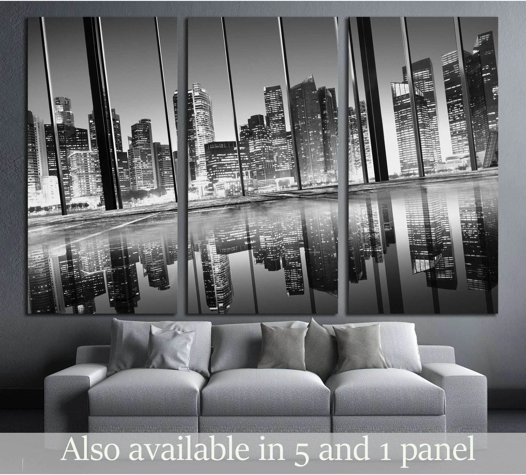 Black and white city skyline triptych canvas print with mirrored reflections above a gray sofa