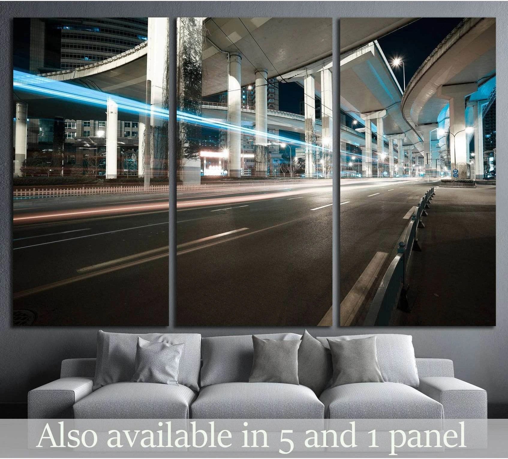 Night city road canvas print with elevated viaducts and blue light trails above a sofa