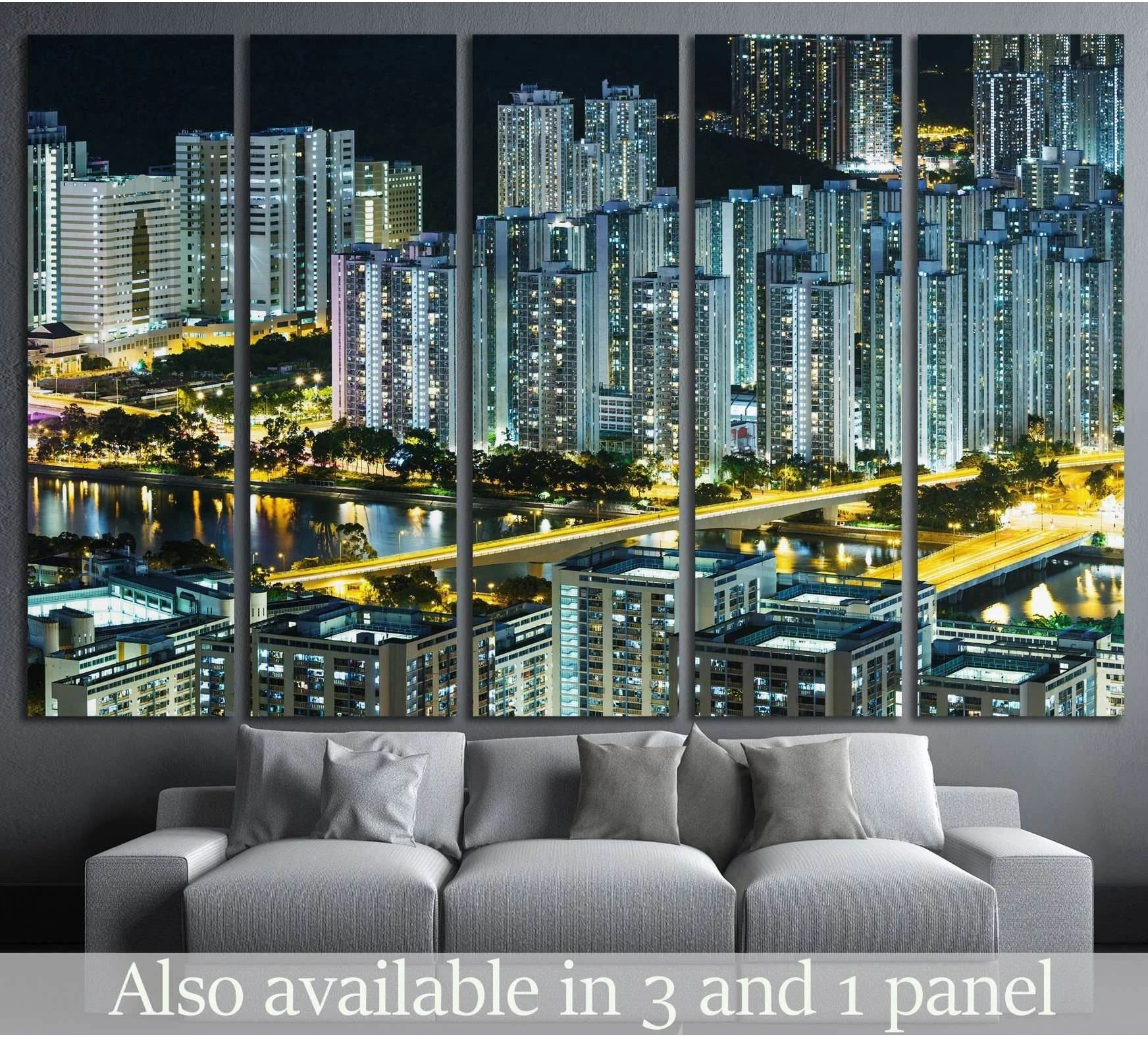 Hong Kong skyline canvas print at night above a gray sofa in a modern living room