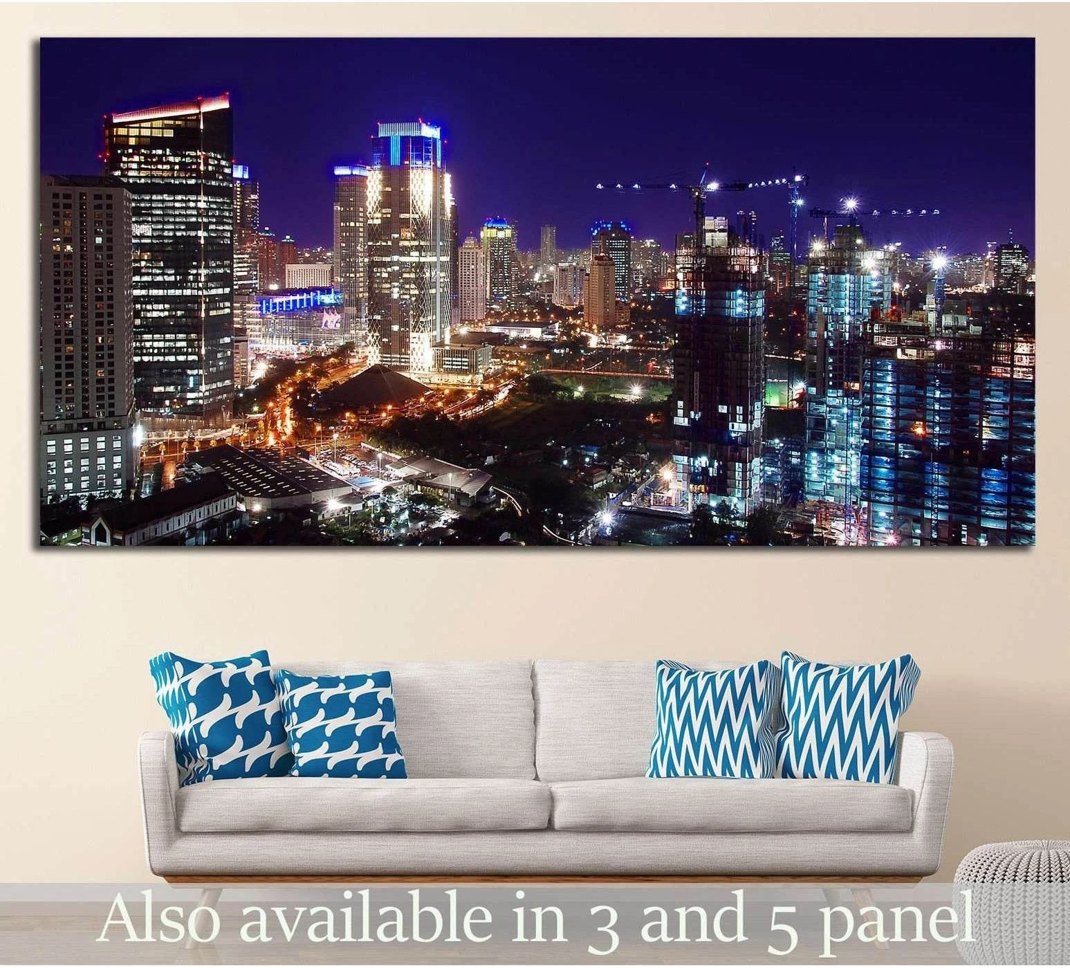 Jakarta skyline canvas print at night with blue and gold city lights above a sofa