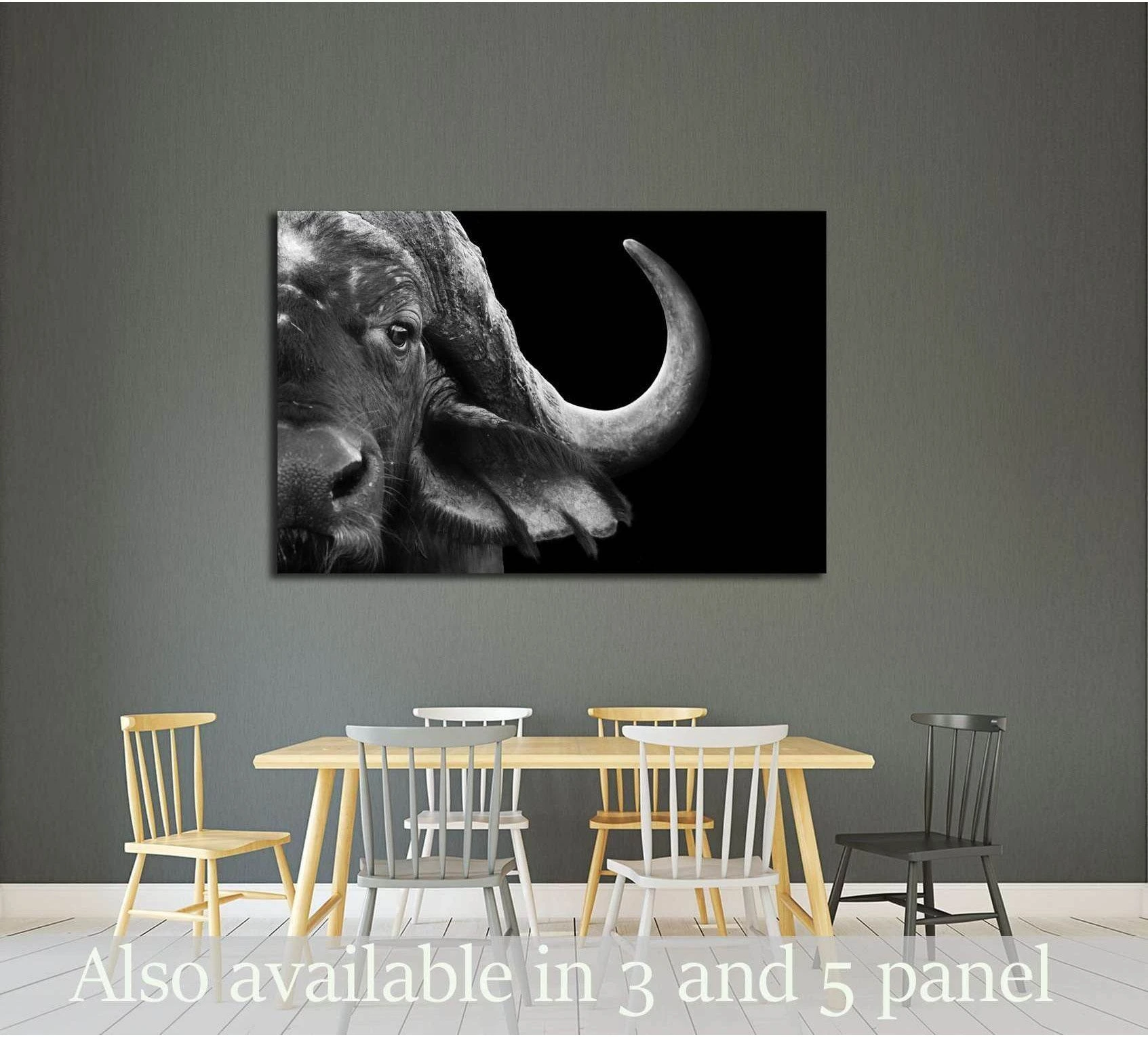 Black and white close-up Cape buffalo canvas print hung above a dining table on a gray wall