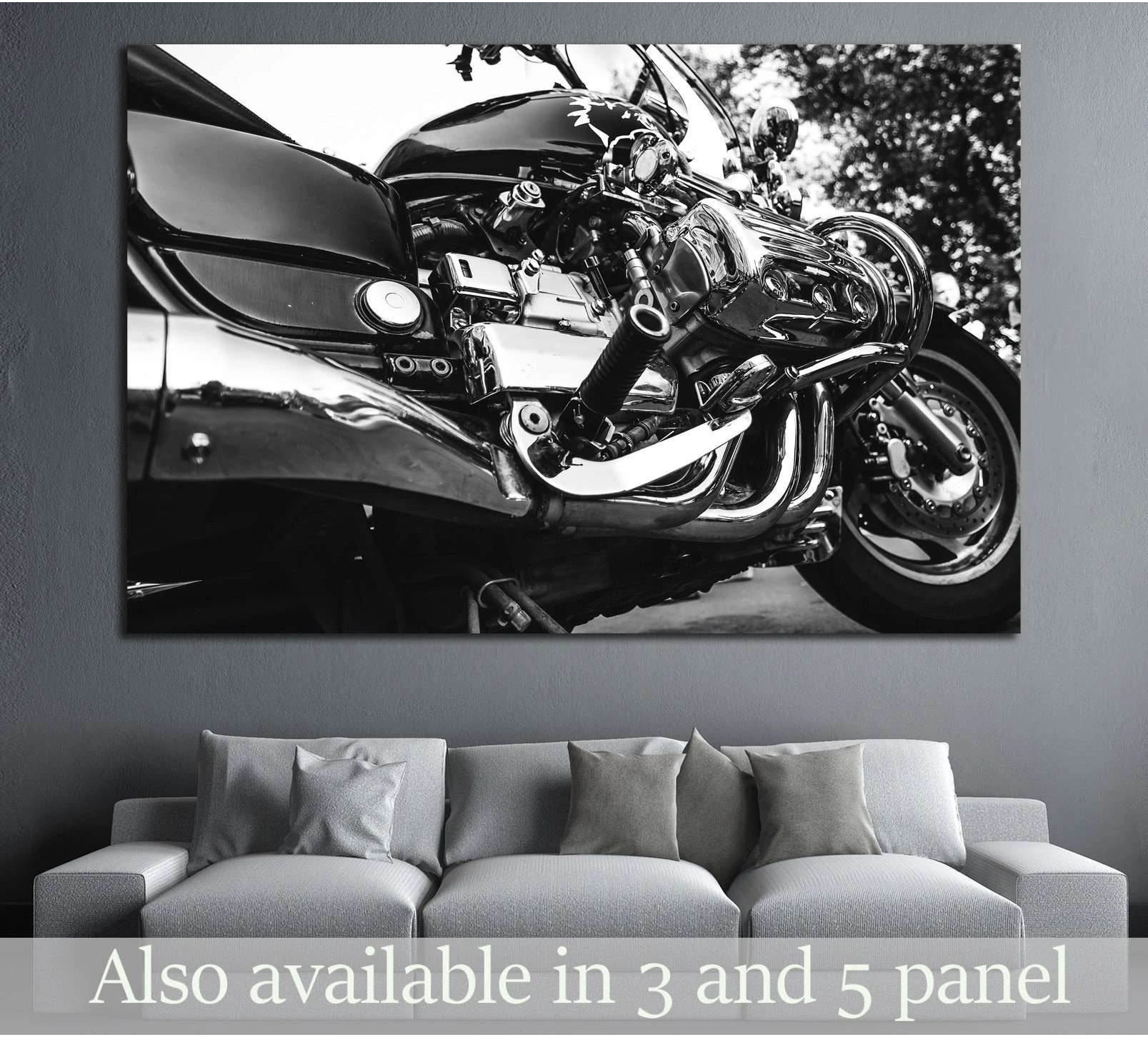 Black and white motorcycle canvas print with chrome engine close-up above sofa in modern living room