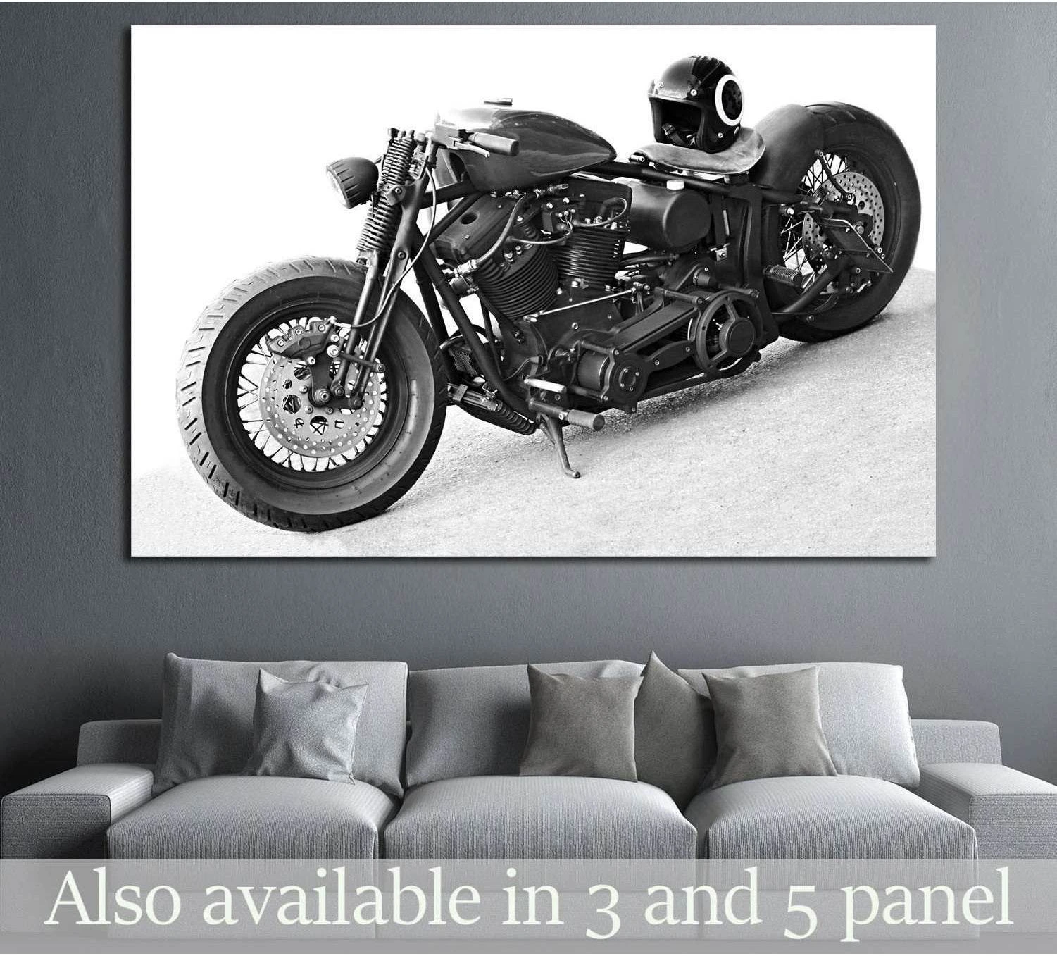 Black and white chopper motorcycle canvas print hung above a gray sofa in a modern living room
