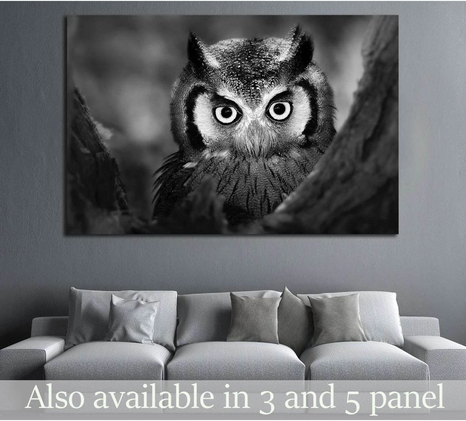 Black and white white-faced owl close-up canvas print hung above a sofa in a modern grey living room