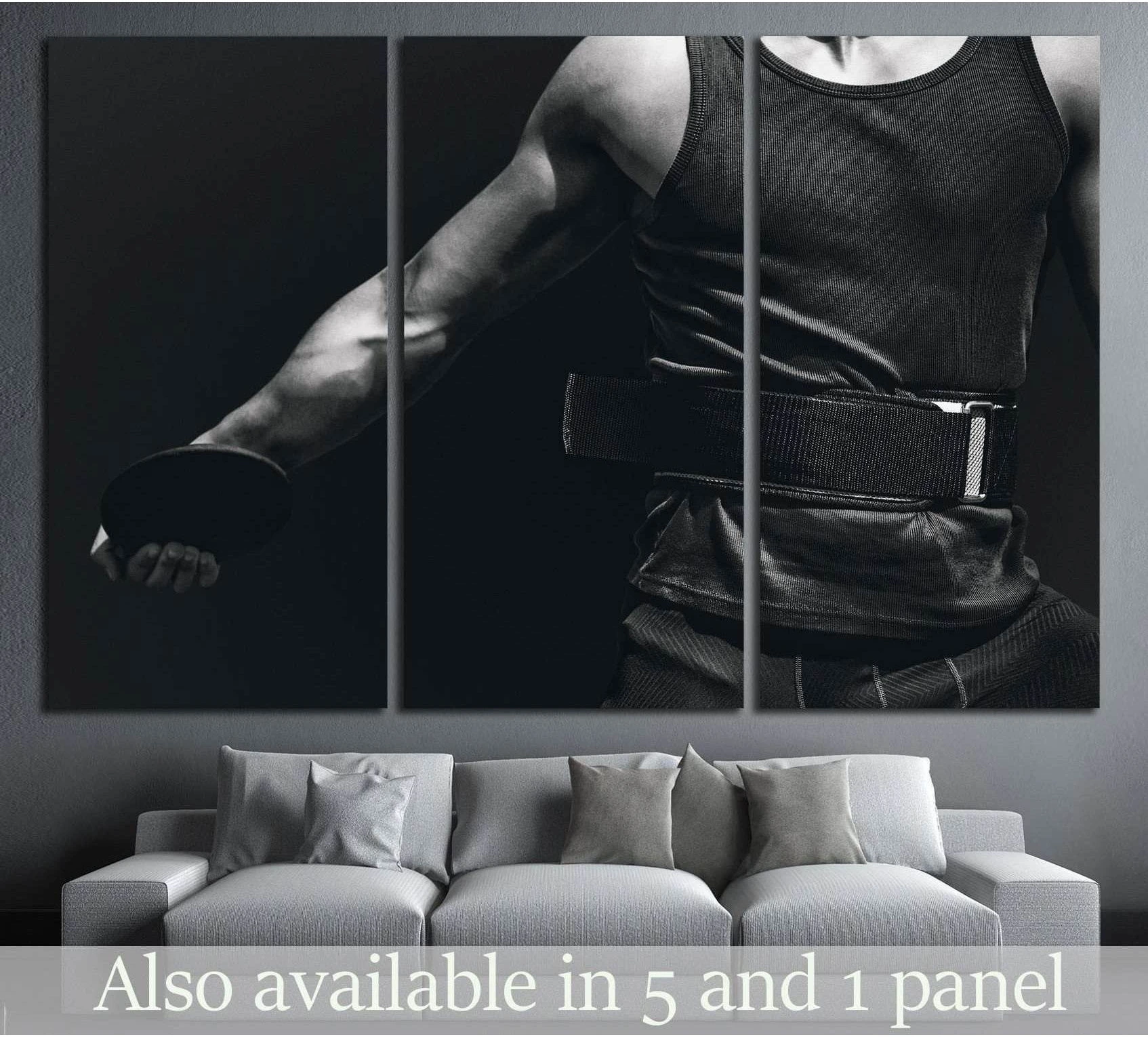 Black and white discus athlete torso canvas print hung above sofa in a modern living room