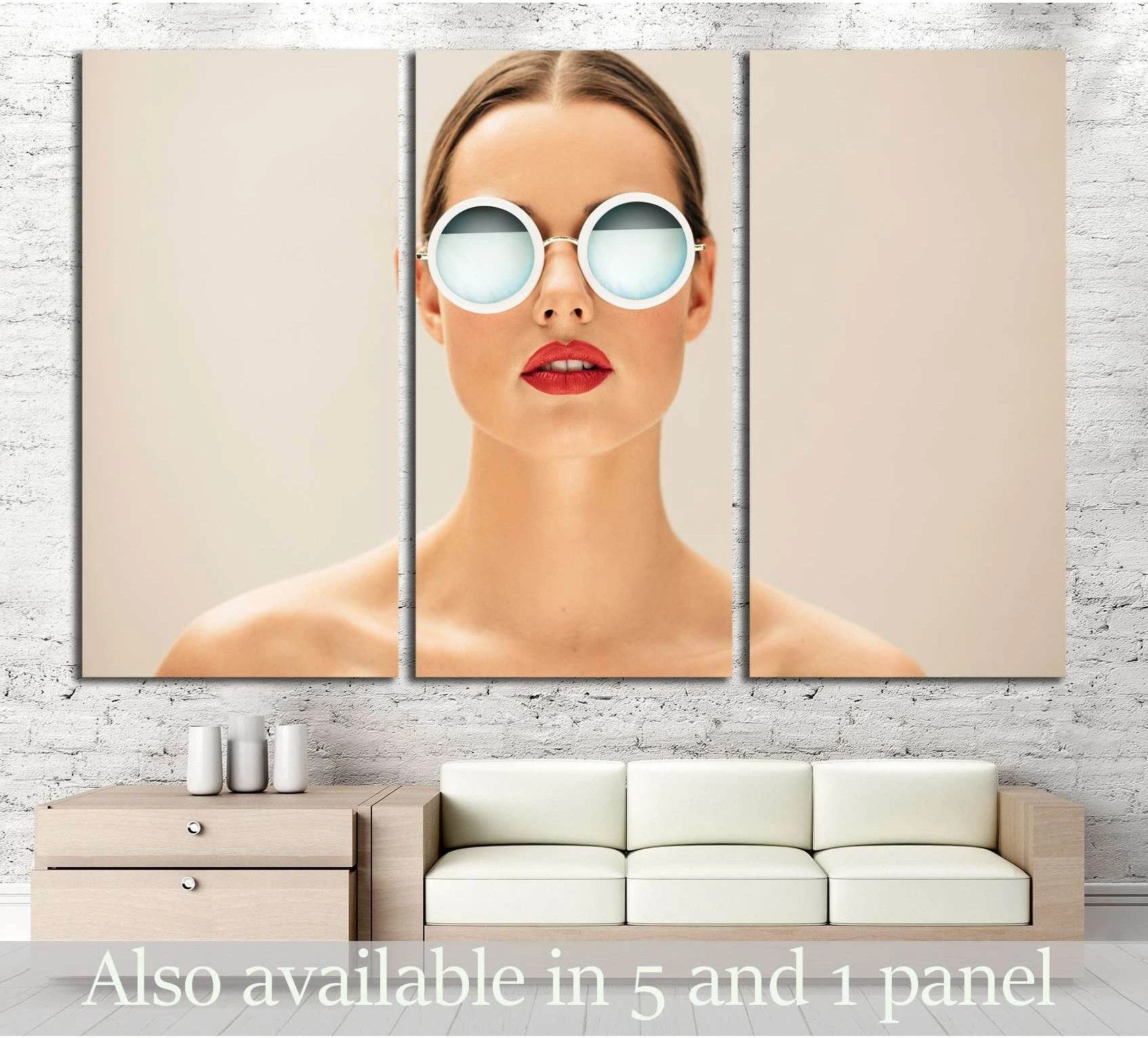 Close-up woman portrait canvas print with round white sunglasses above sofa in beige room