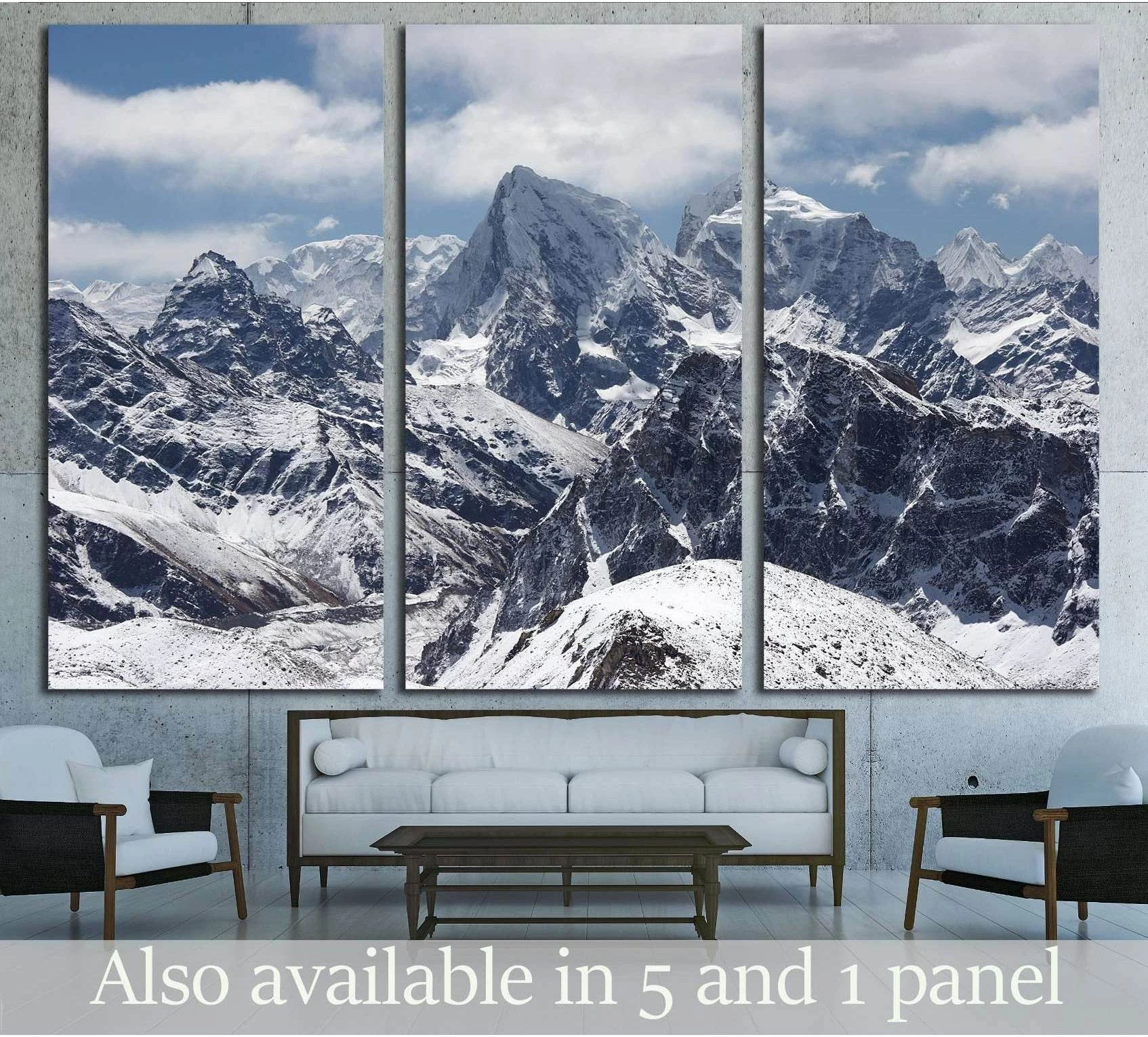 Snow-covered Himalaya mountain peaks canvas print in a triptych above a sofa in a modern living room