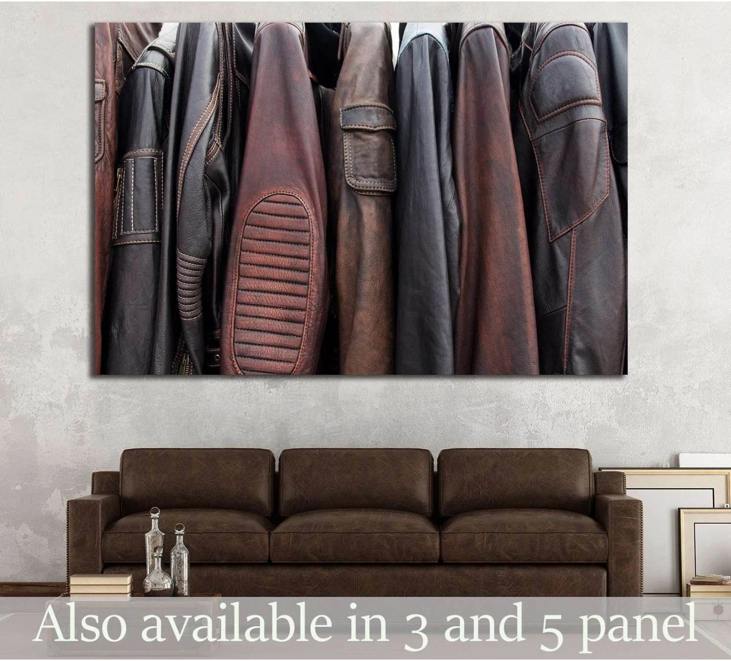 Brown and black leather jackets on hangers canvas print above a brown sofa in an industrial room