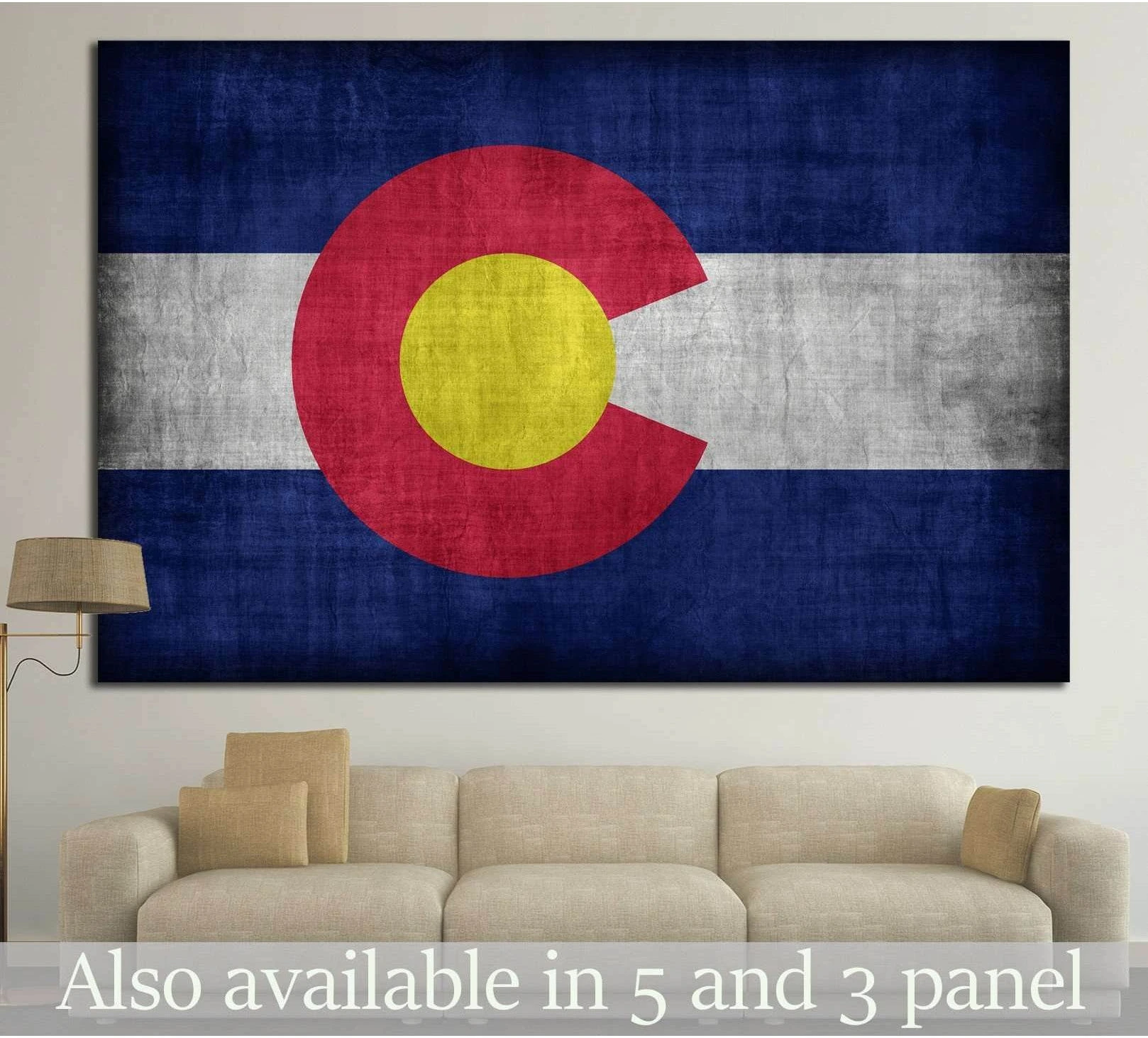 Colorado flag canvas print with distressed vintage texture hung above a beige sofa in a neutral living room