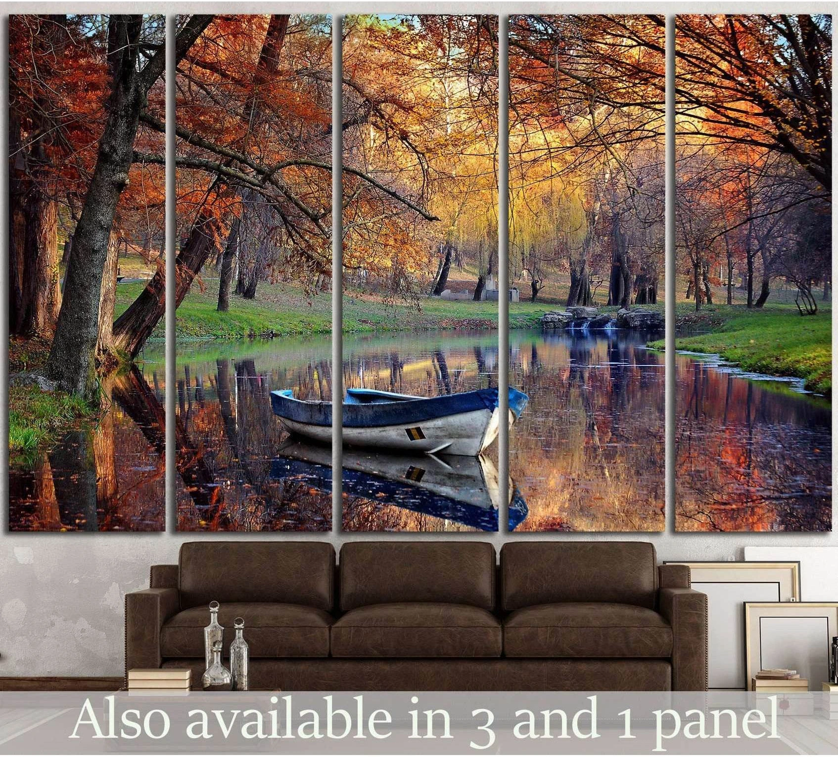 Autumn lake rowboat canvas print above sofa with fall trees and water reflections