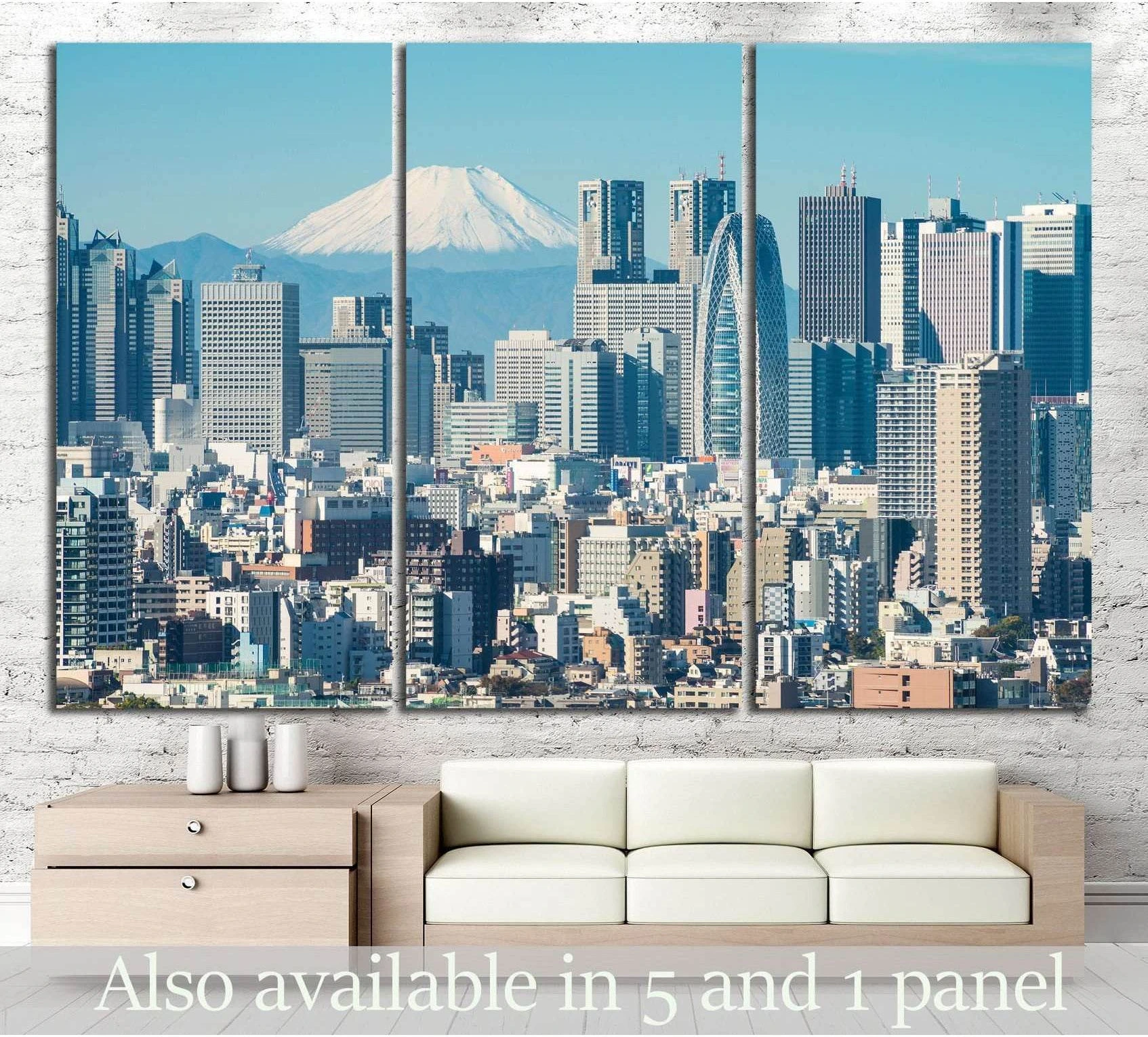 Tokyo skyline canvas print with Mount Fuji behind modern skyscrapers, shown as triptych wall art above a sofa