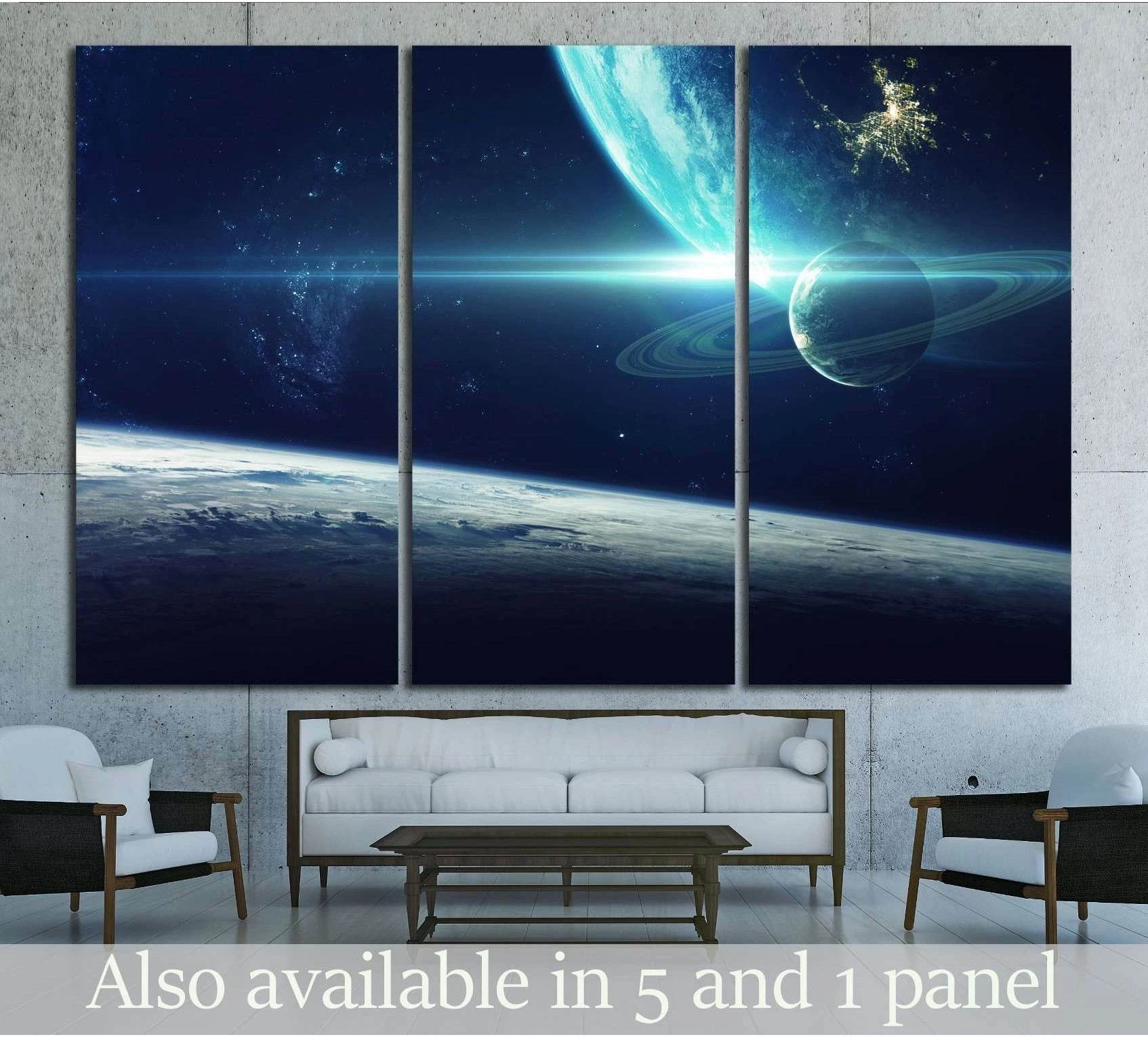 Triptych ringed planet canvas print above sofa in modern living room with deep blue outer space scene