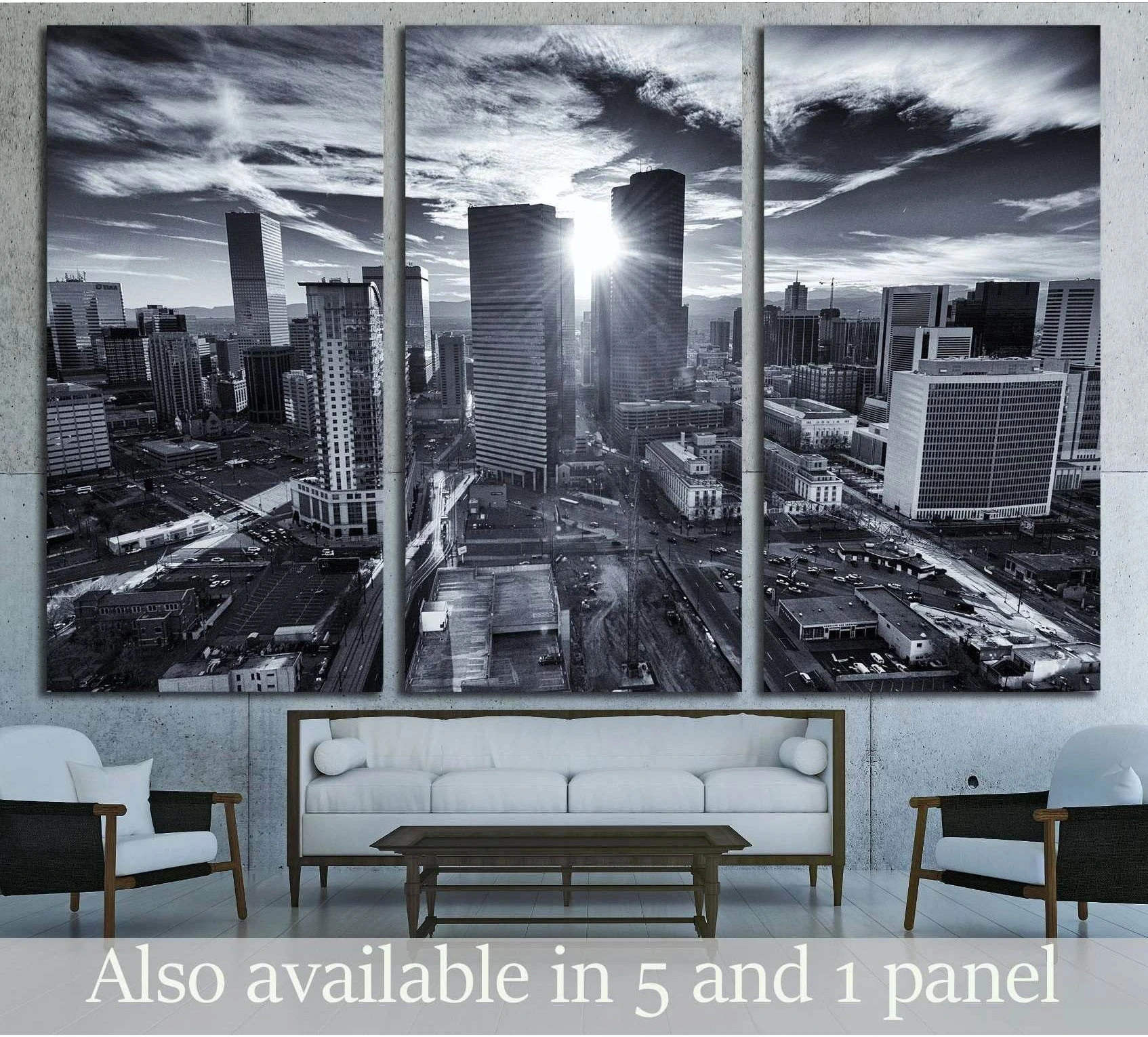 Black and white city skyline canvas print with sunburst between downtown towers above a sofa