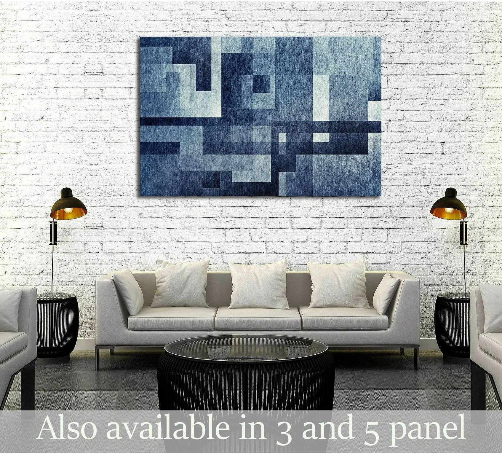 Indigo geometric abstract canvas print with textured blue grid blocks hung above a sofa in a modern living room