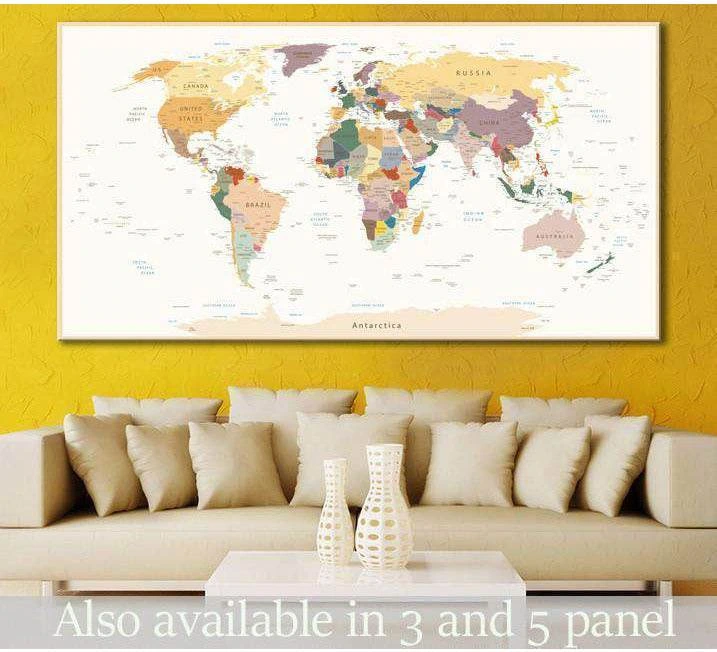 Pastel world map canvas print with labeled countries hung above a sofa in a modern office